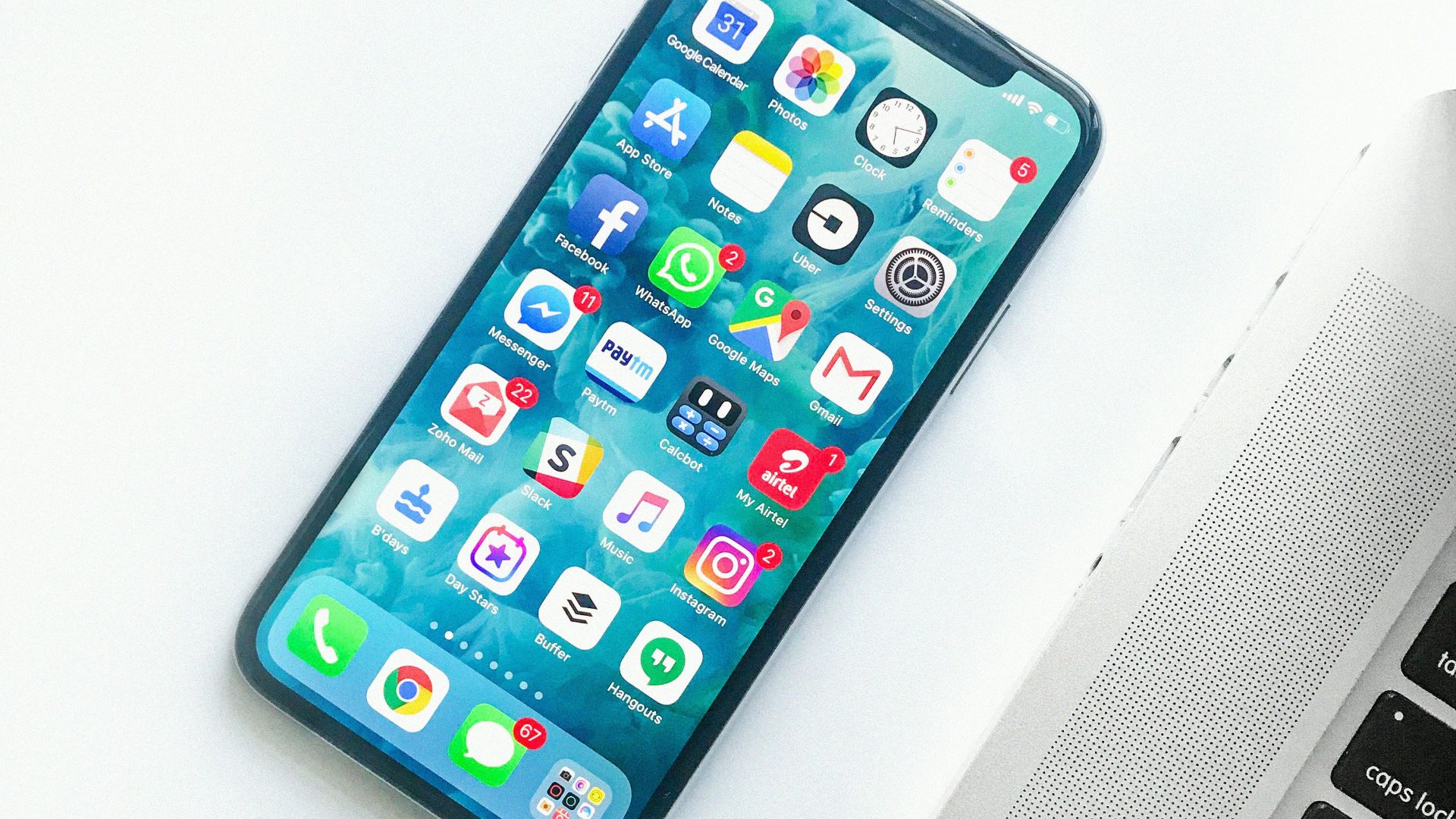 white smartphone near laptop