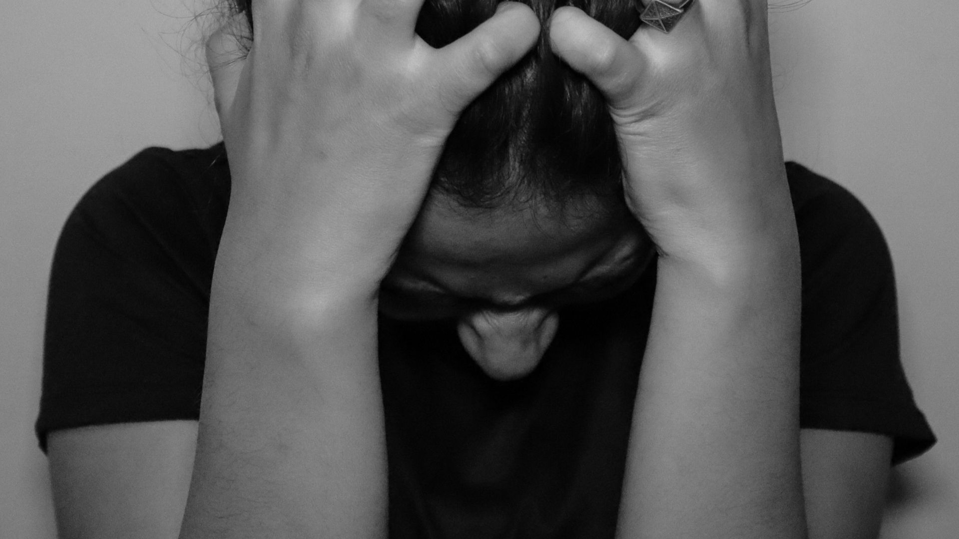 a woman covering her face with her hands