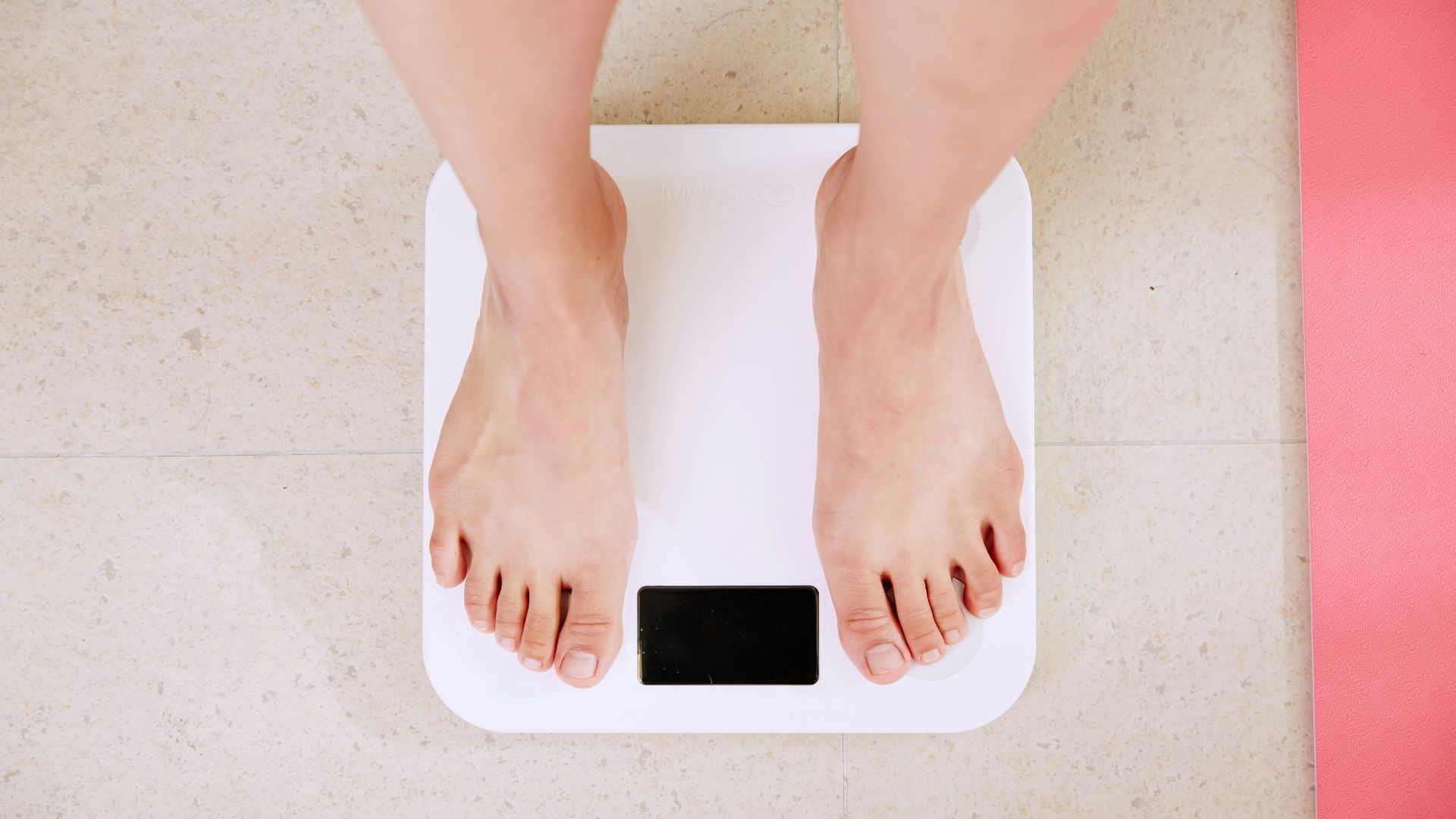 person standing on white digital bathroom scale