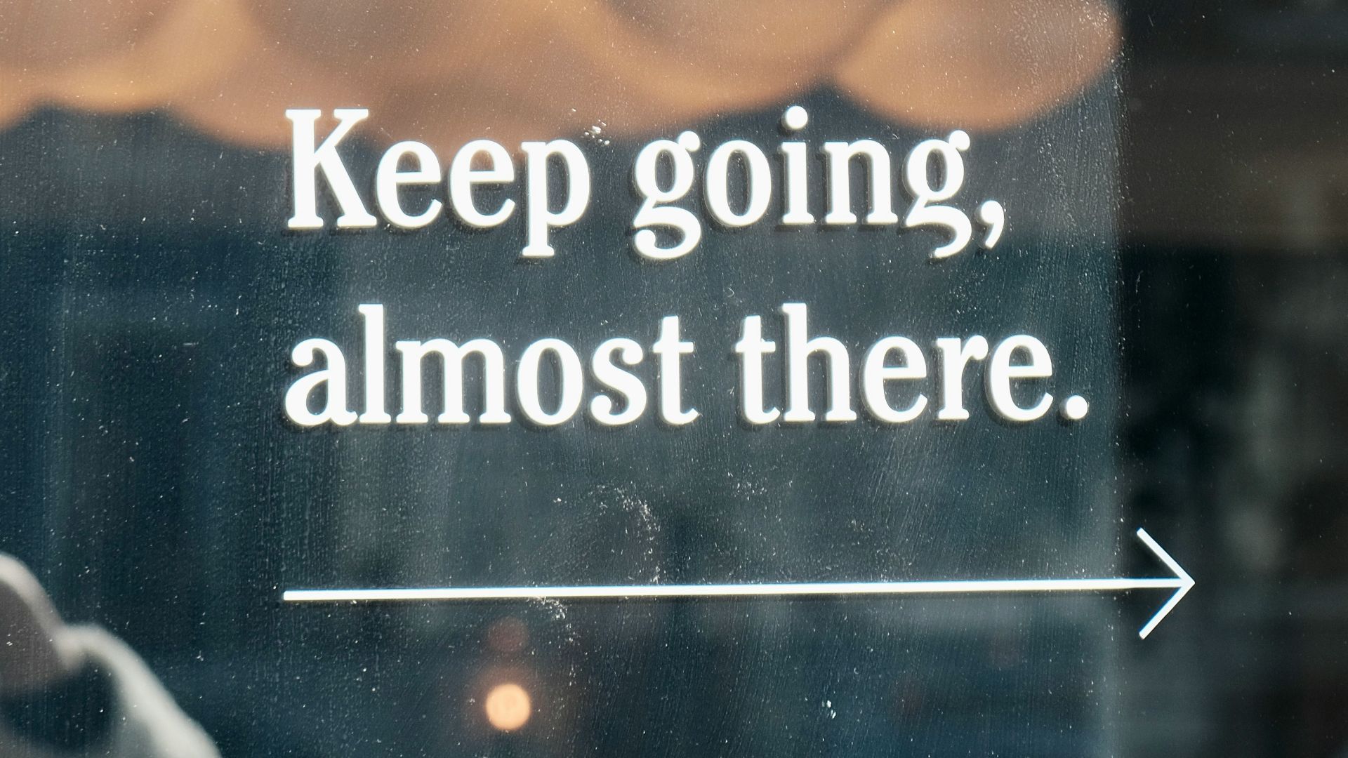 a window with a sign that says keep going, almost there