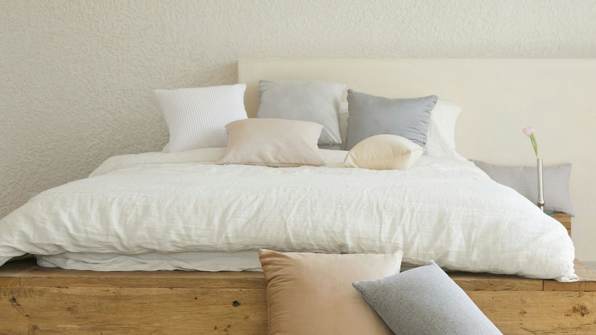 white bed pillow on brown wooden bed frame