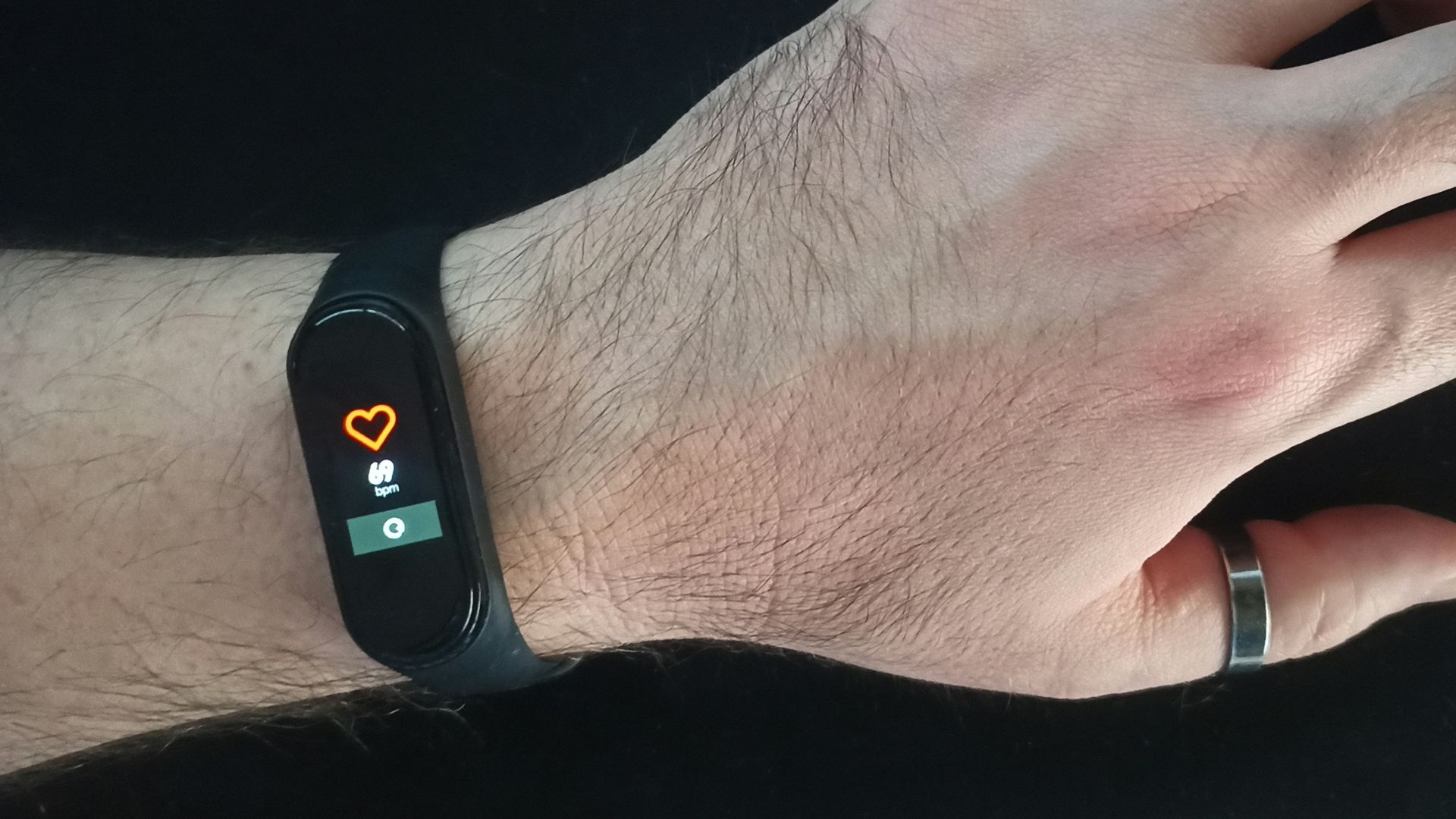 person wearing black and silver ring