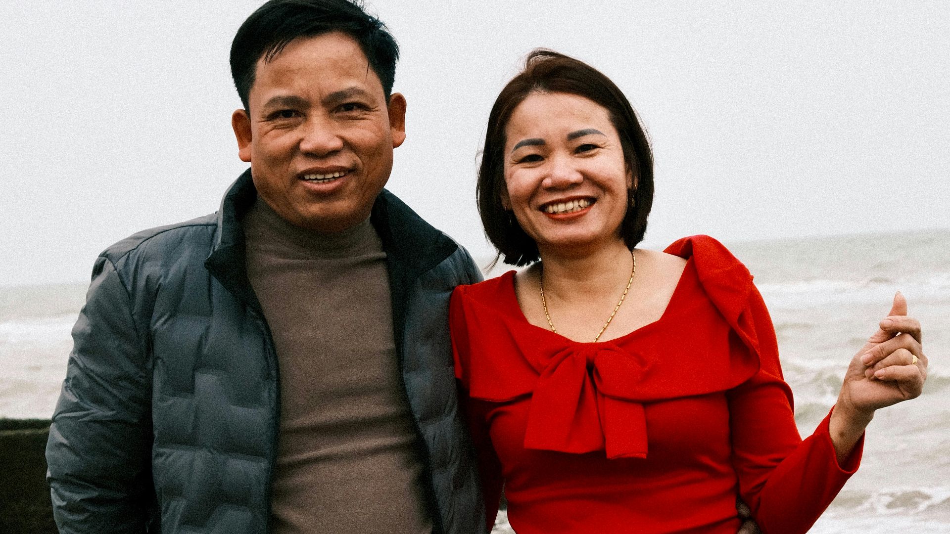 a man standing next to a woman on a beach