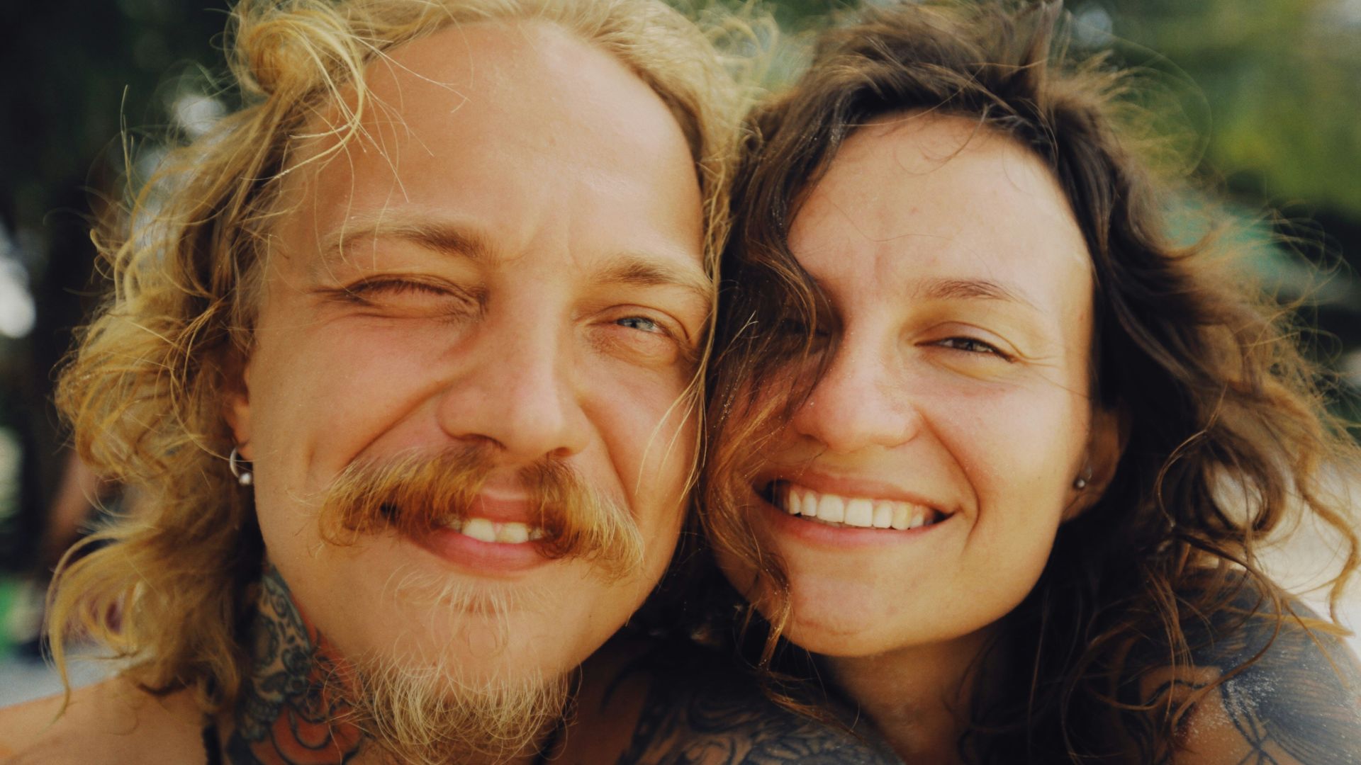 woman in black and brown floral shirt smiling