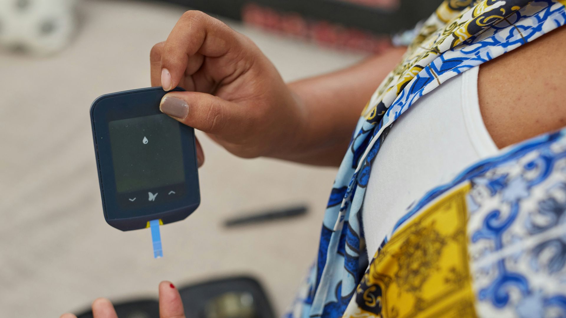 a person using a gluco-meter