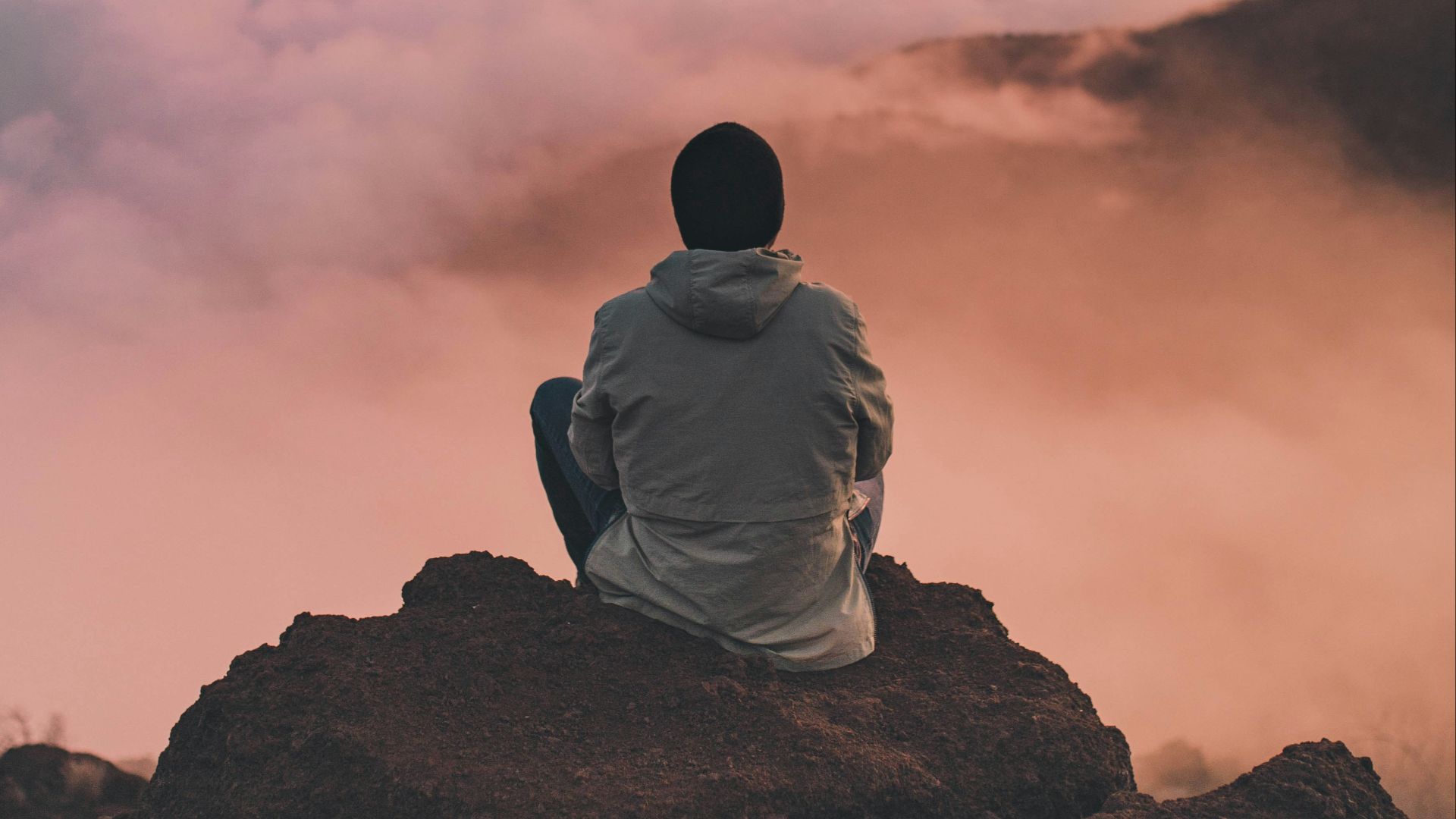 man sitting on cliff