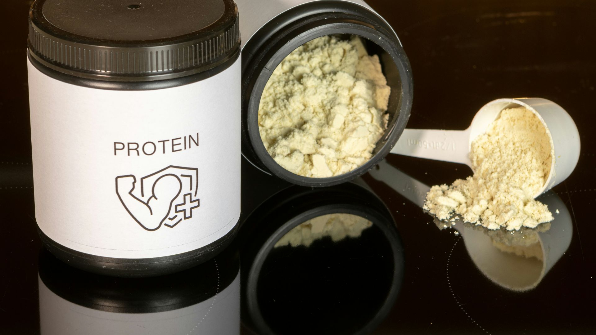 a jar of protein powder next to a spoon