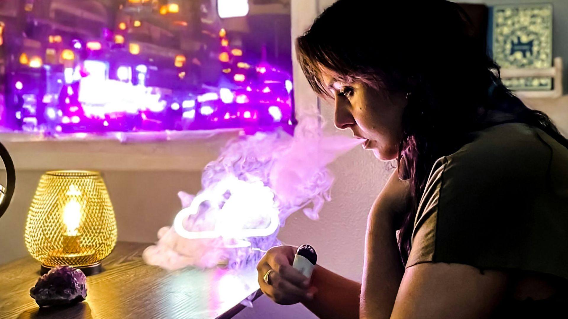 a woman sitting at a table with a lit candle