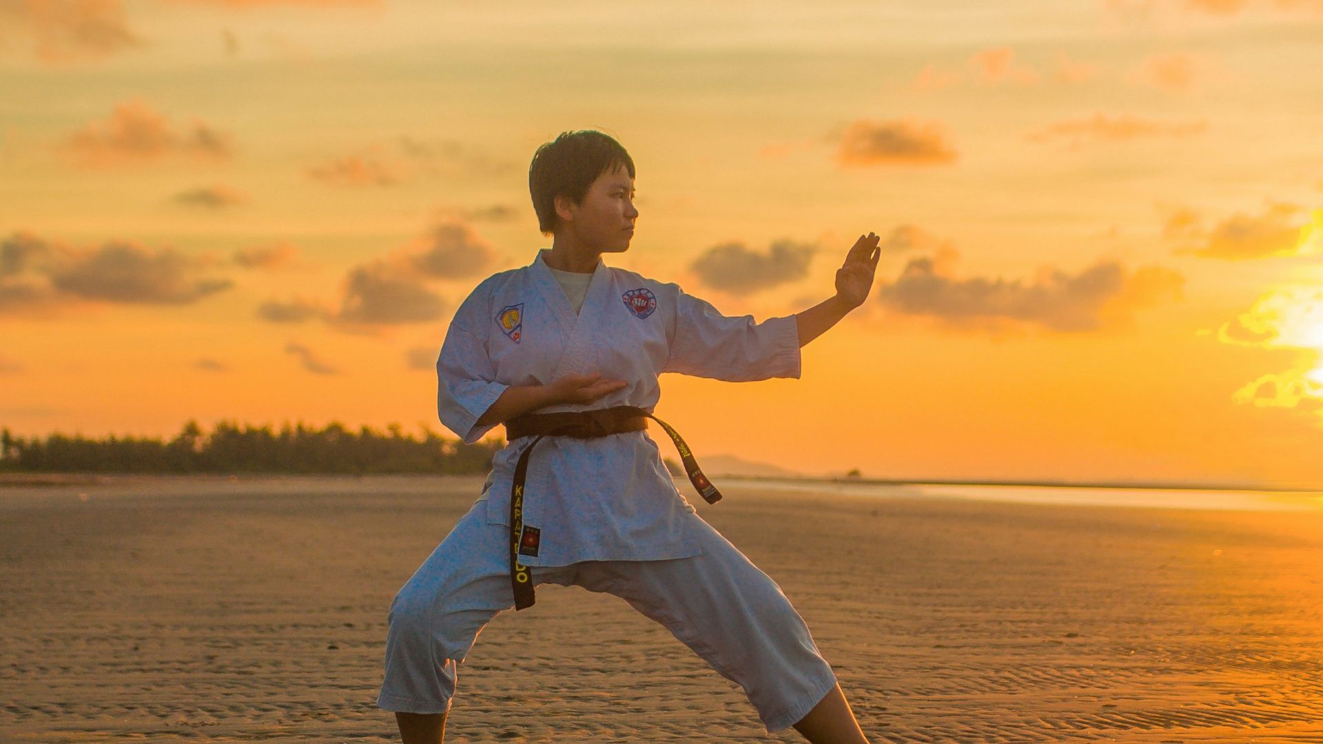 boy doing karate routines during golden hour