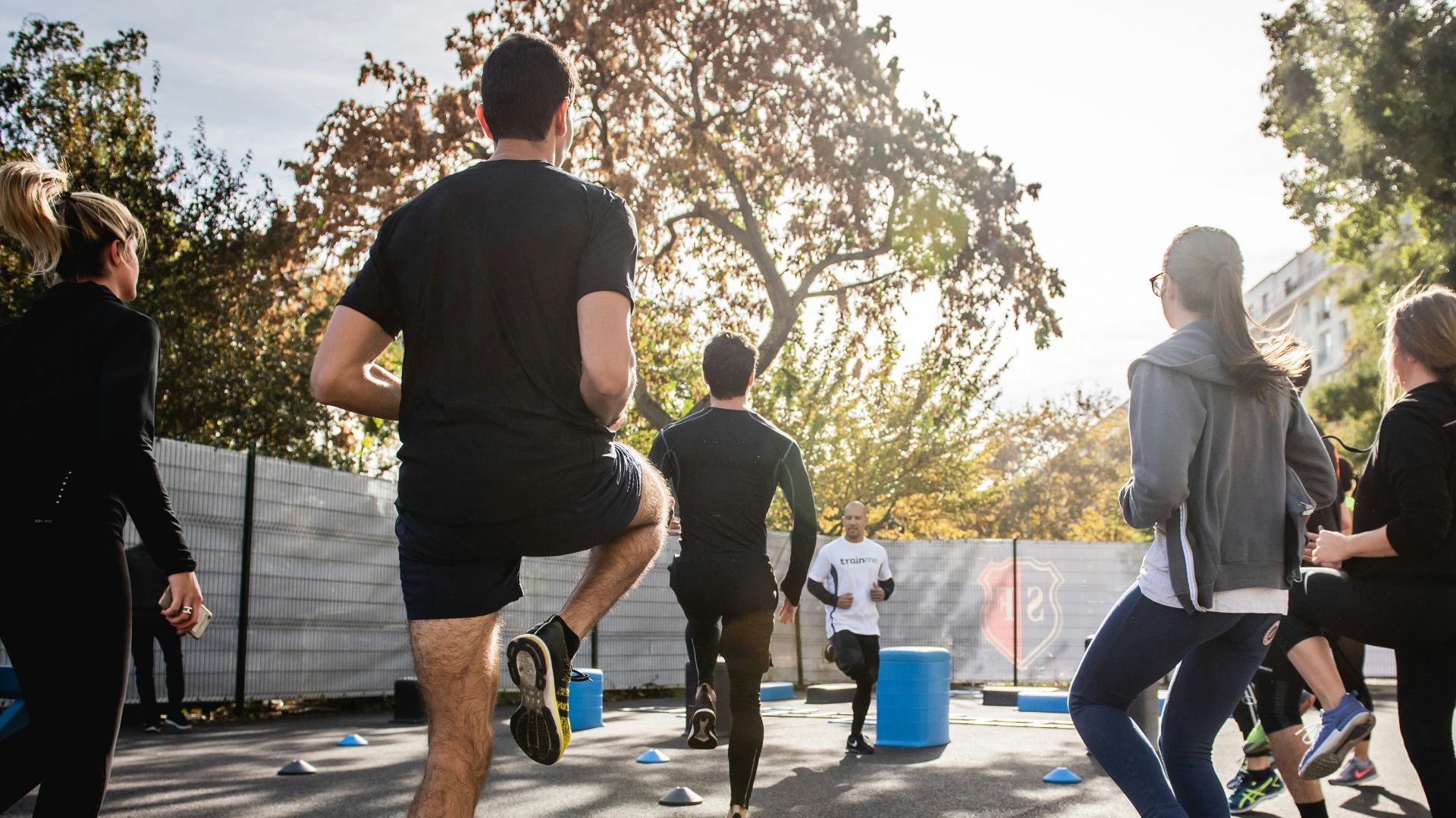 man in black t-shirt and black shorts running on road during daytime