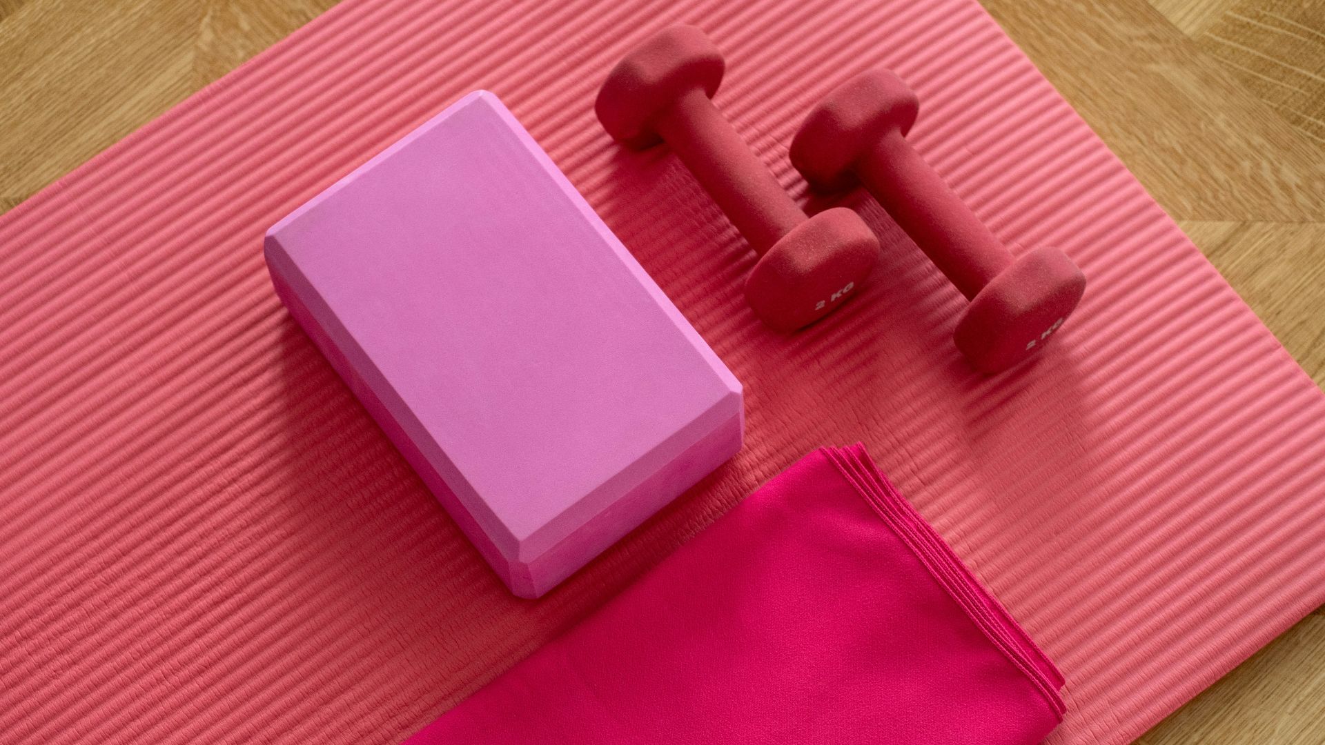pink dumbbell on pink textile