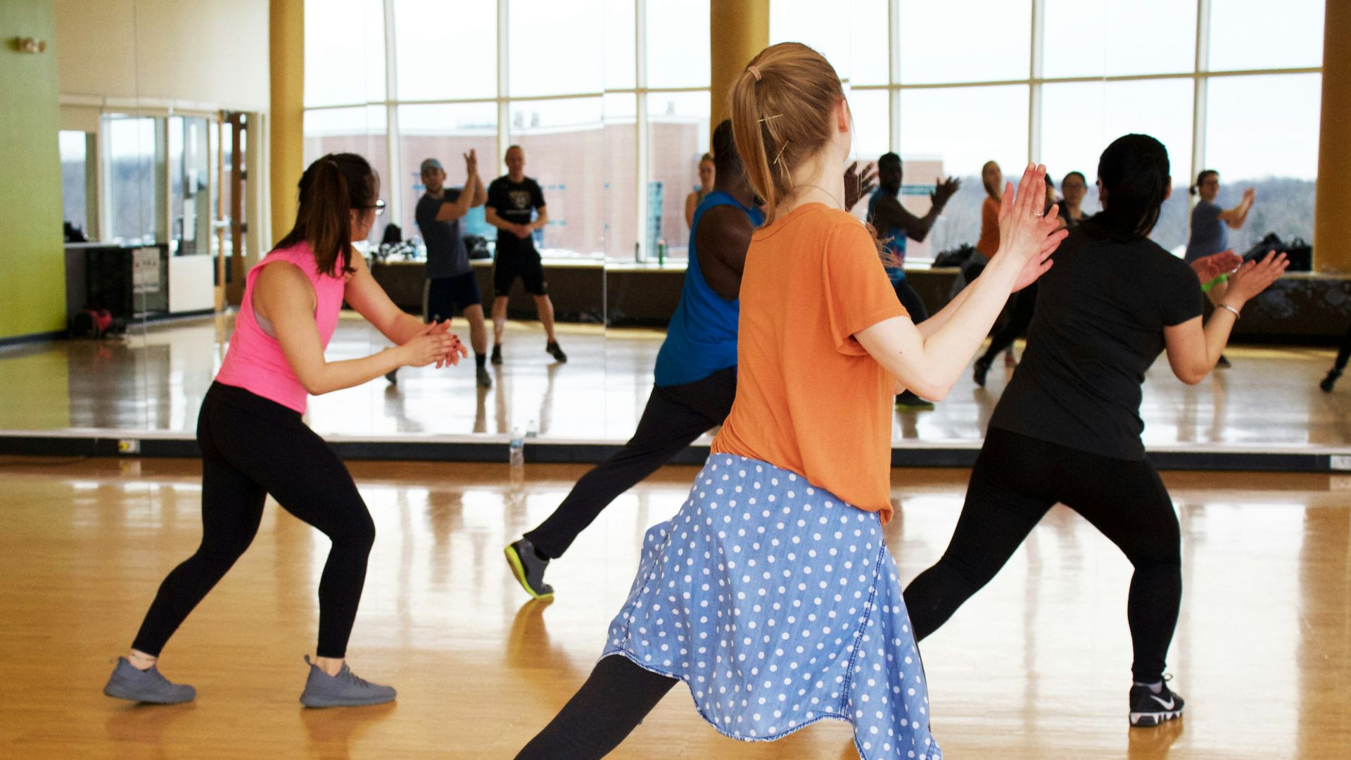 women dancing near mirror