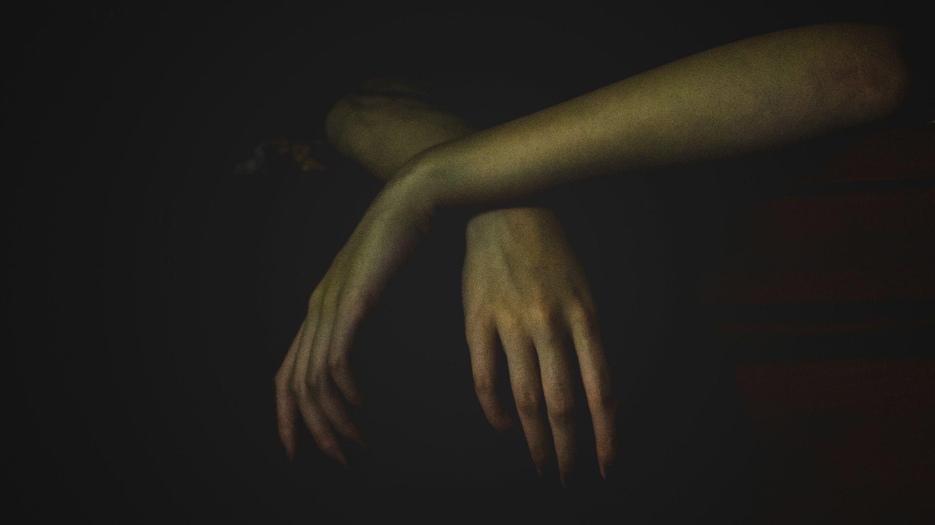 a person's hand reaching for something in the dark