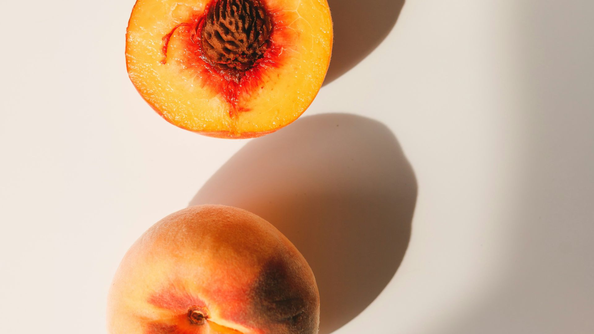 2 red and yellow peach fruits