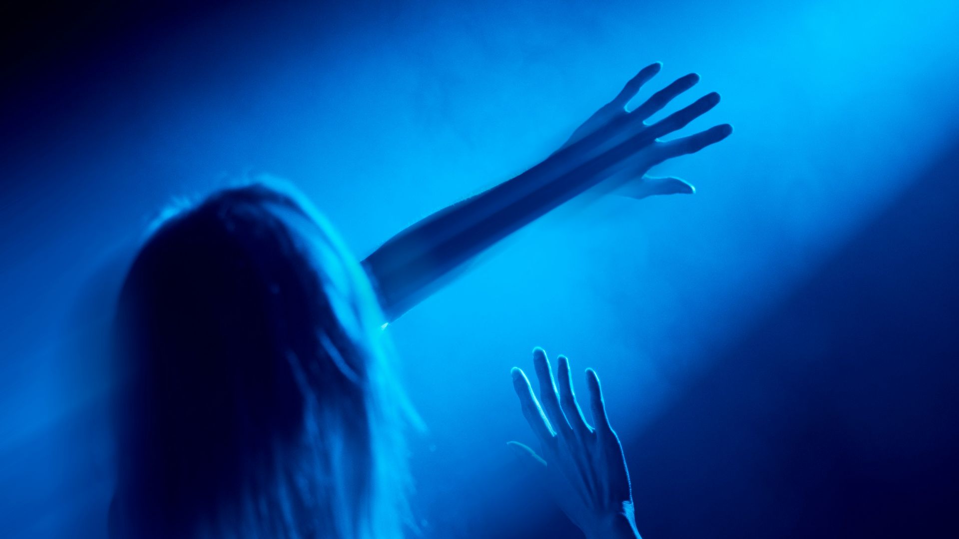 woman in black tank top raising her hands