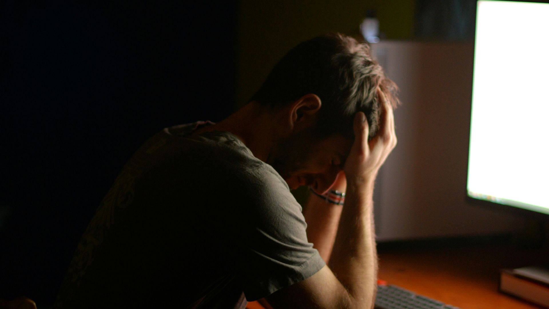 a man sitting at a desk in front of a computer