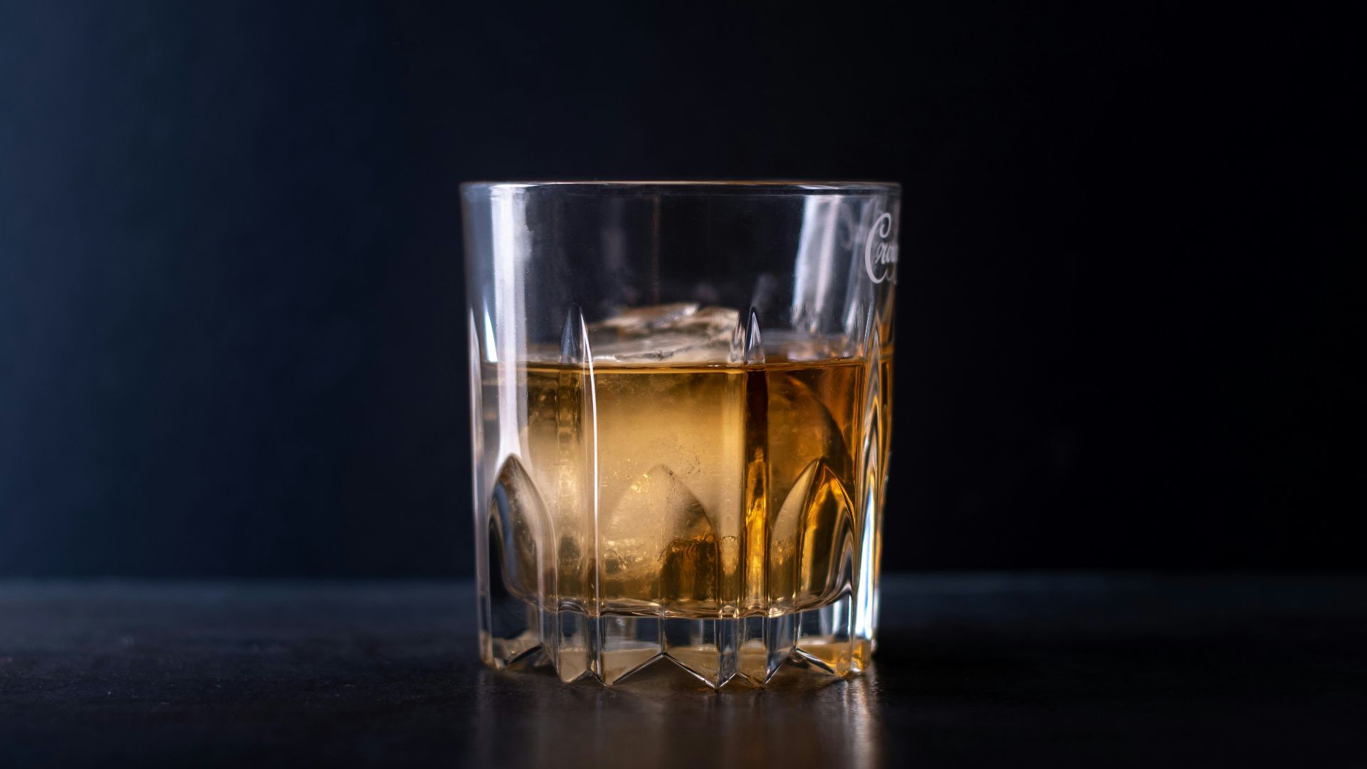 clear shot glass with brown liquid
