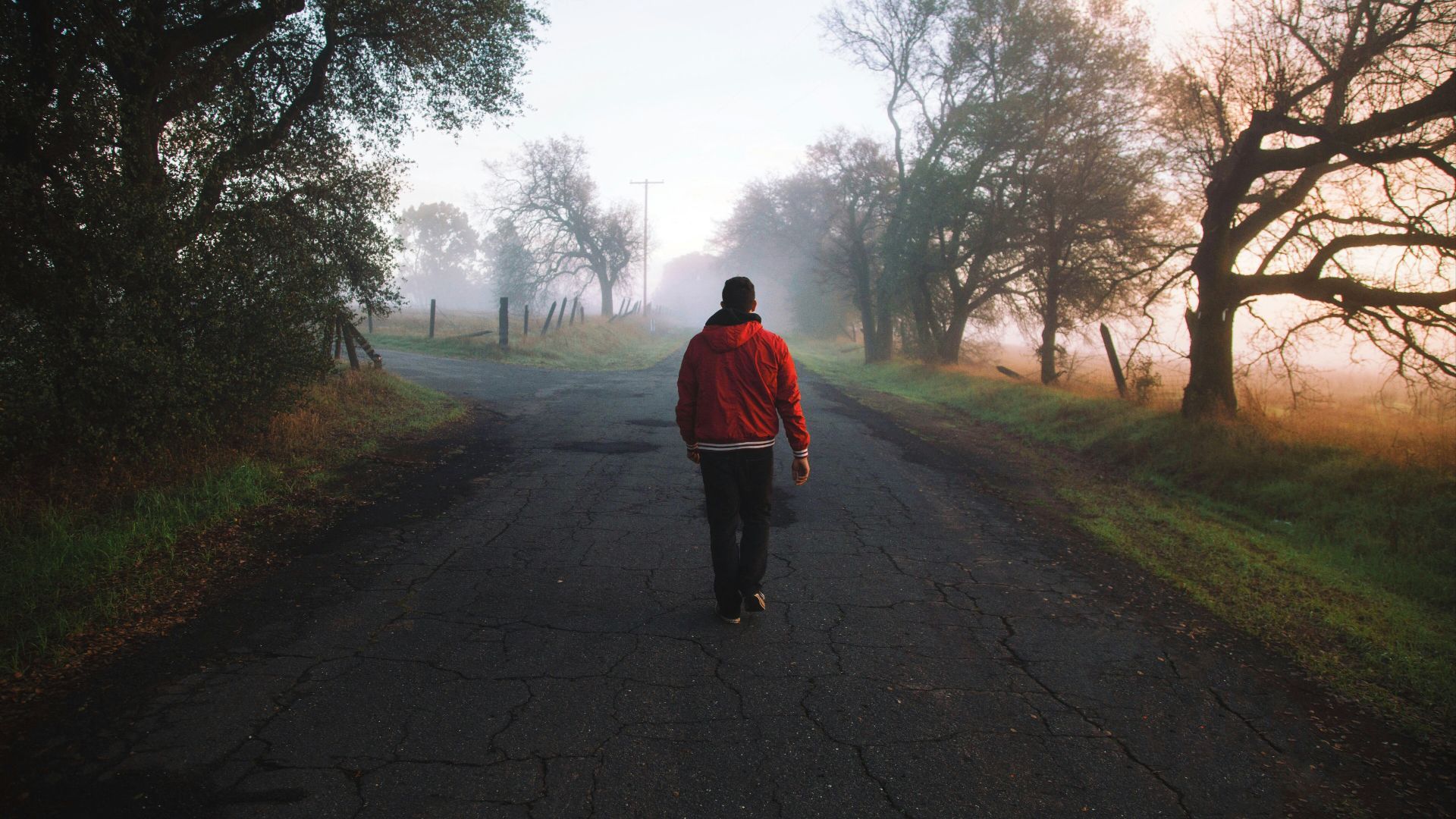 man walking on road at daytime