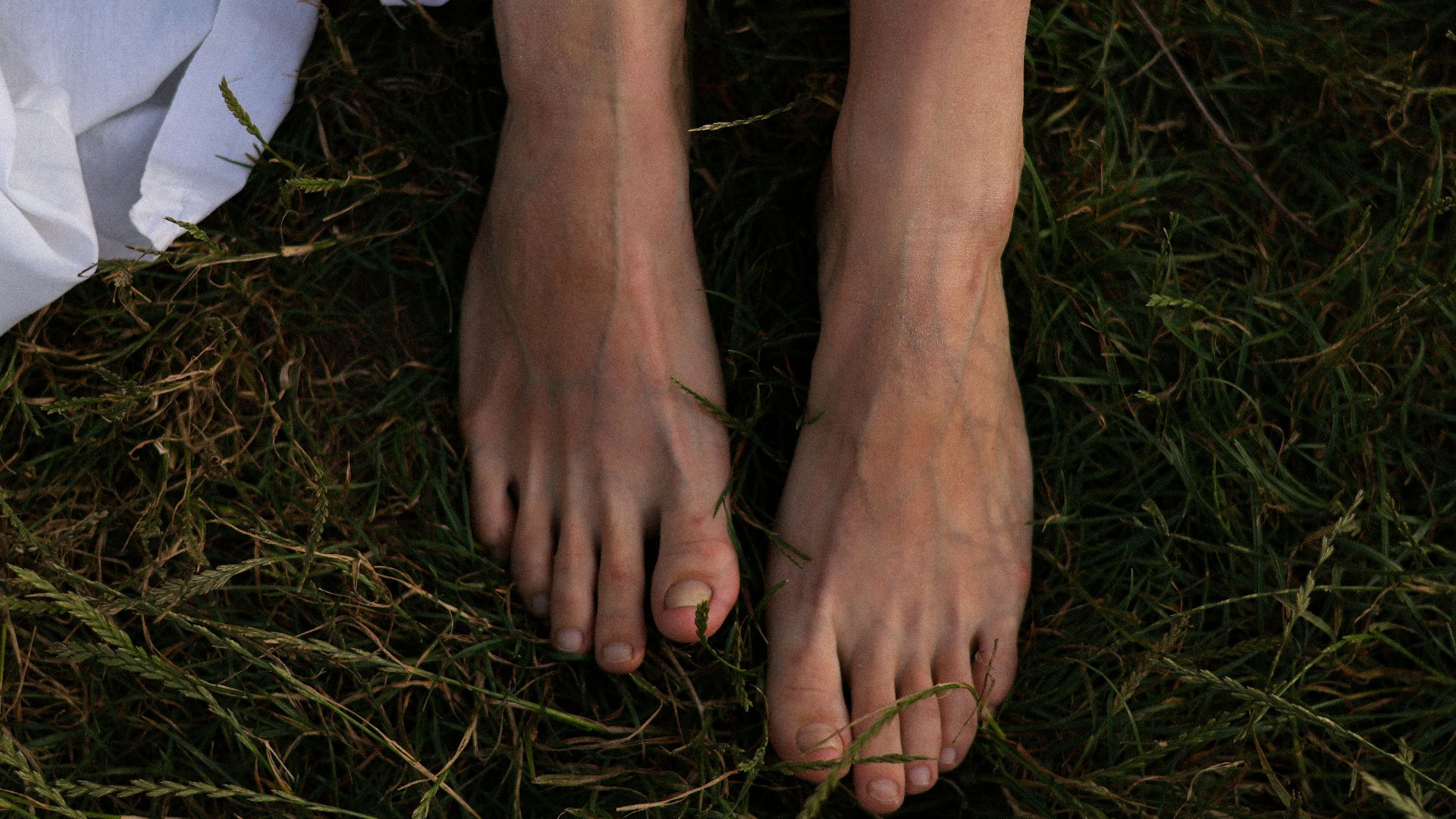 a woman's bare feet in the grass