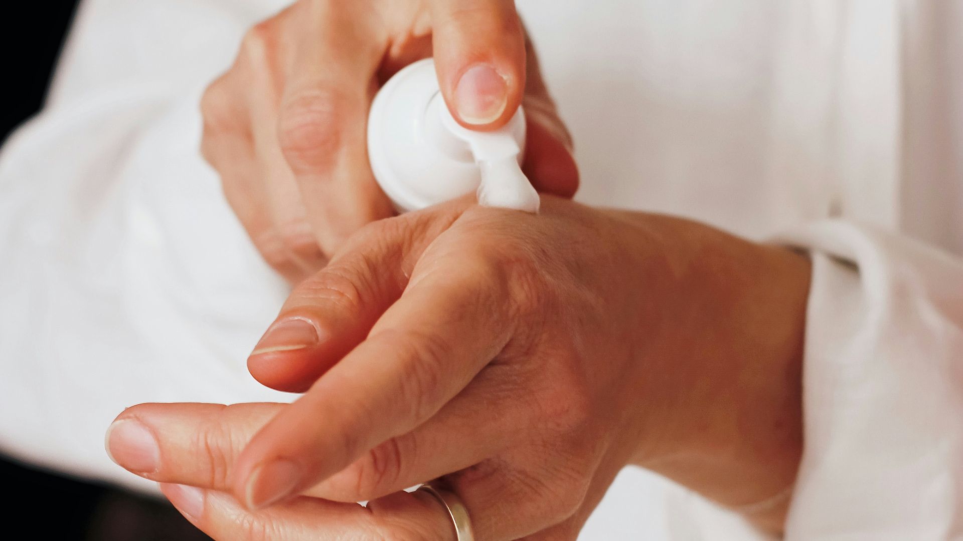 person holding white round ornament