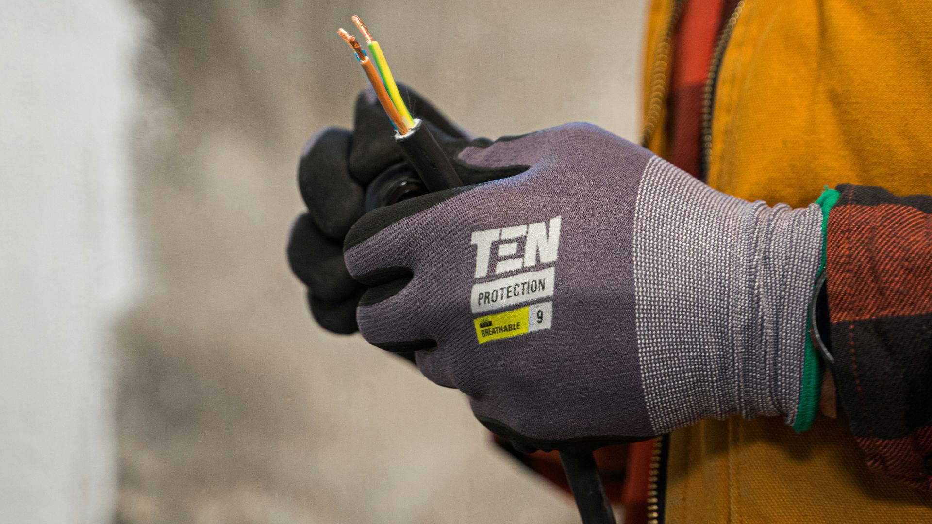 a person wearing gloves holding a pair of scissors