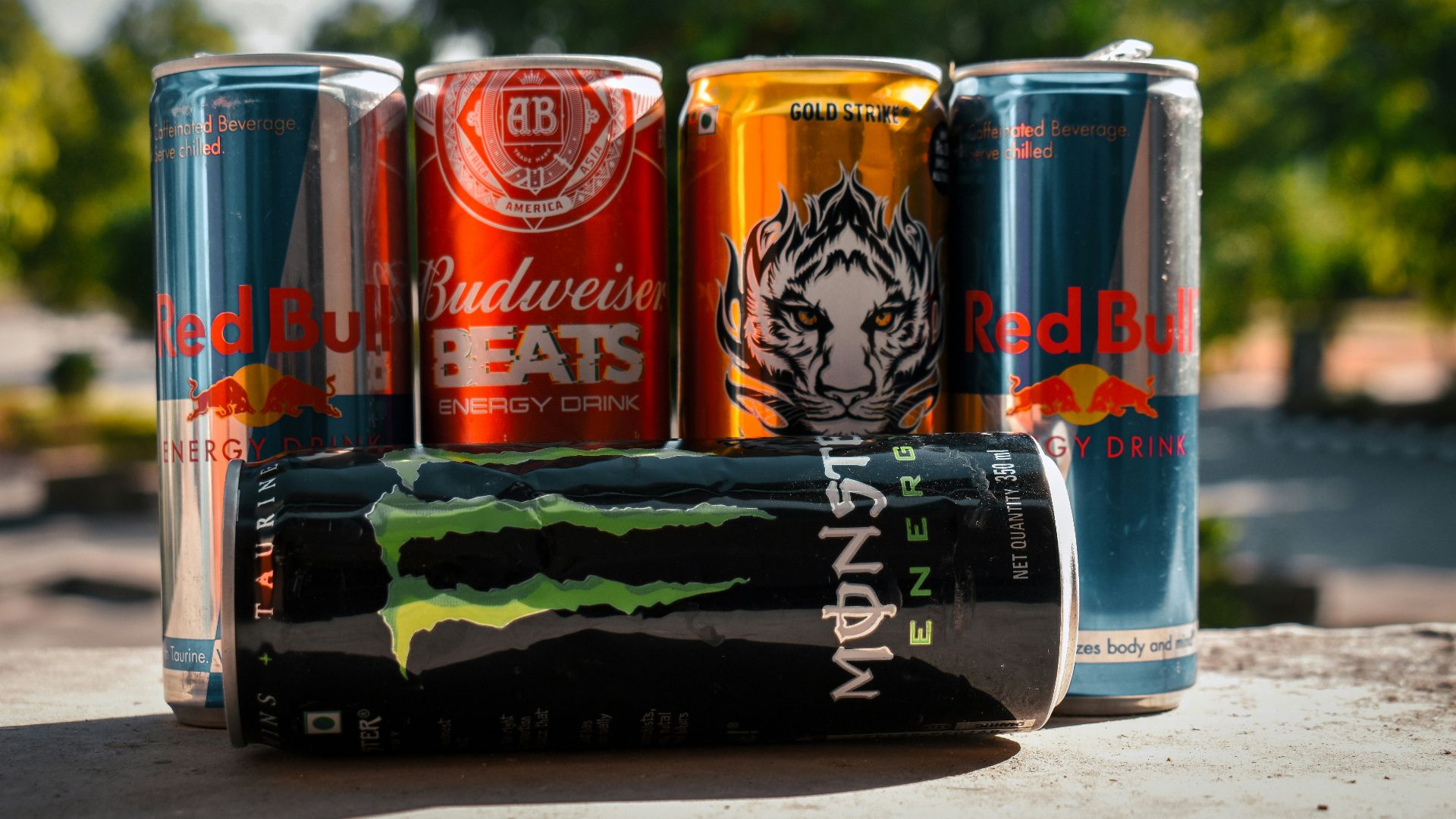 a group of four cans of soda sitting next to each other