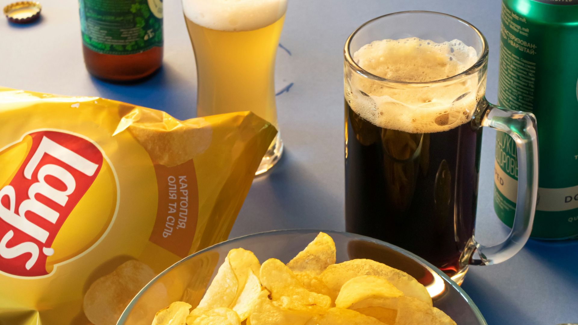 clear drinking glass beside brown bread on blue ceramic plate