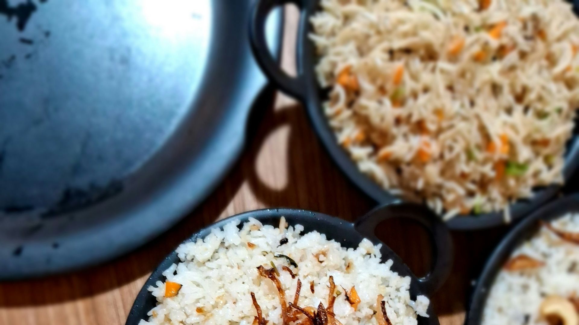 a wooden table topped with bowls of food