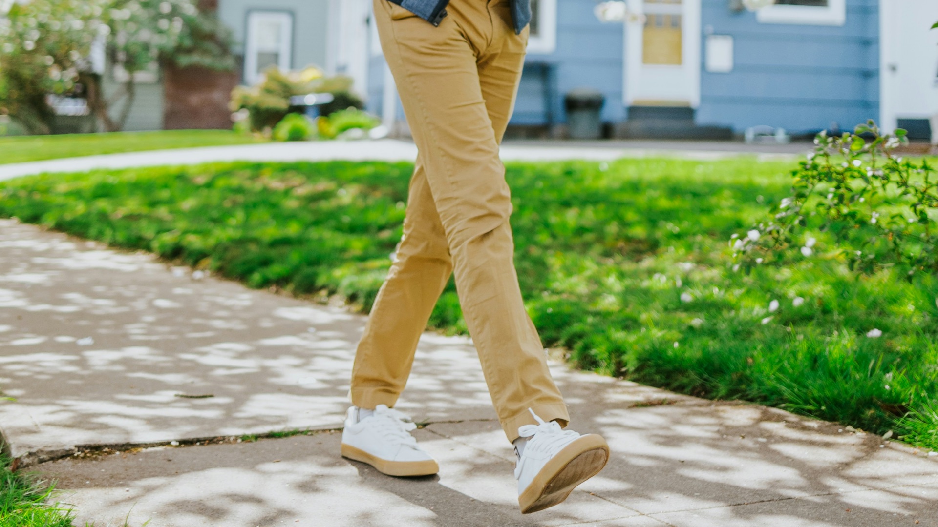 man in blue jacket standing on pathway during daytime