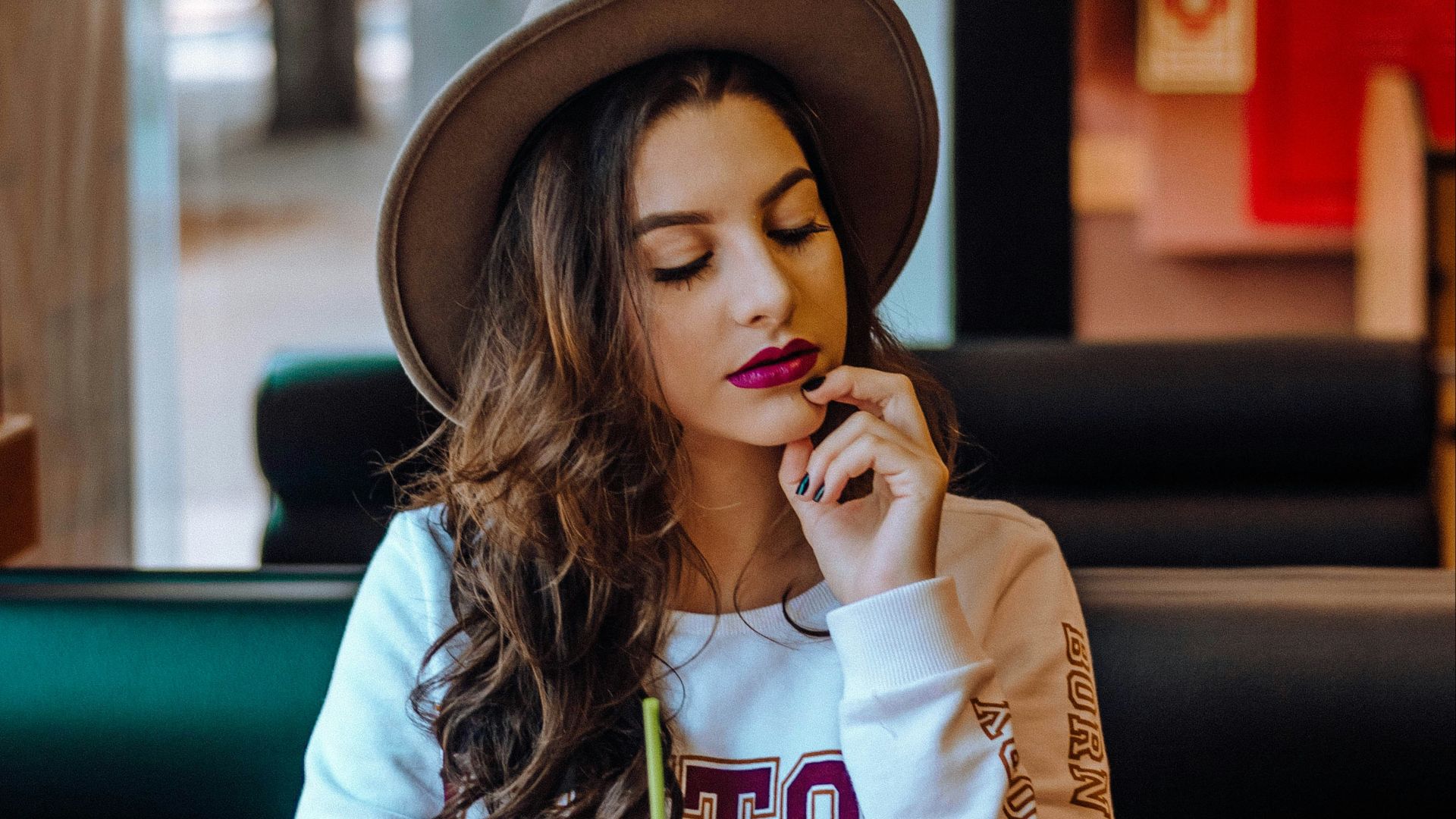 closed eye woman wearing brown hat