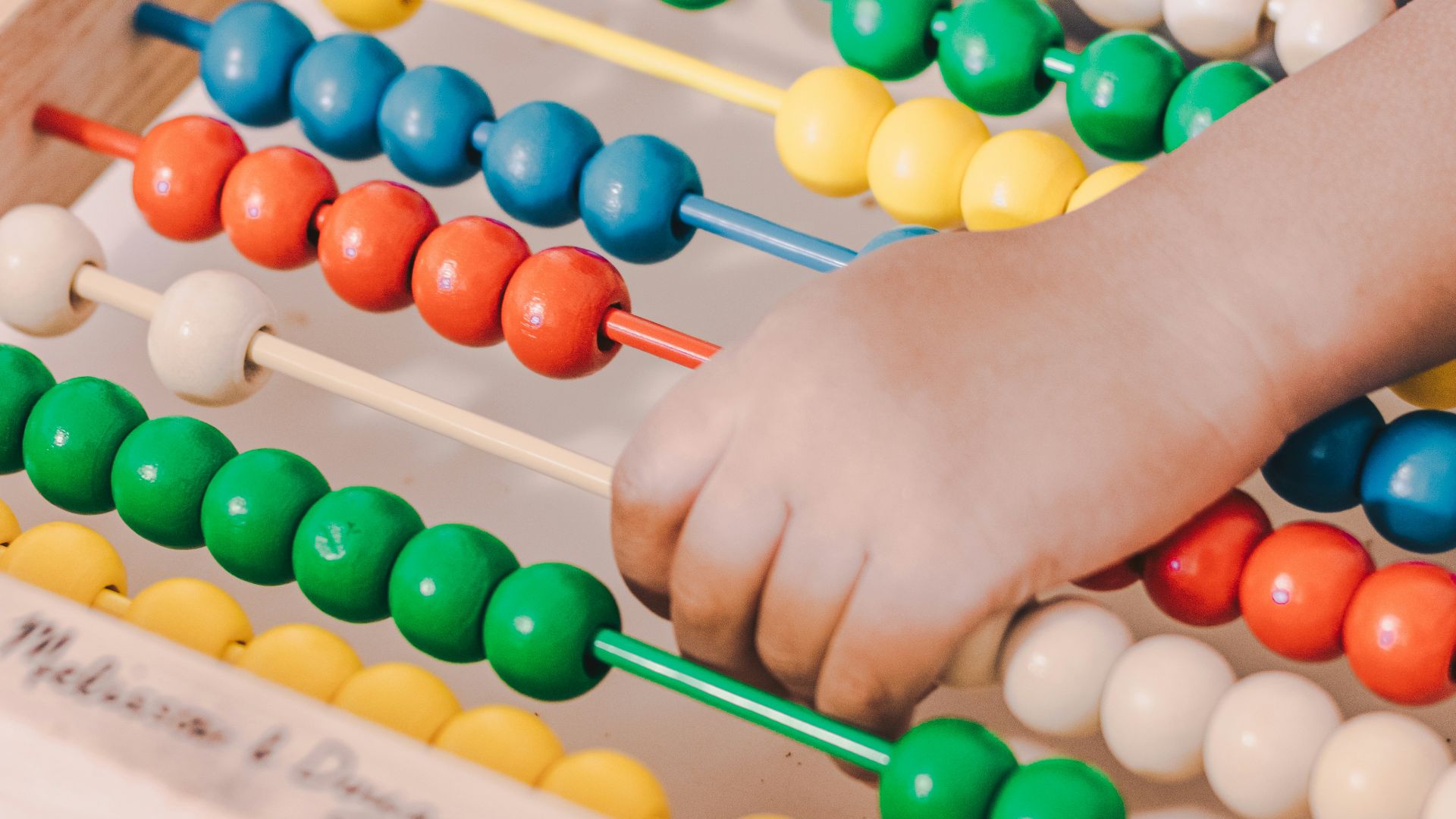 person holding red and blue abacus