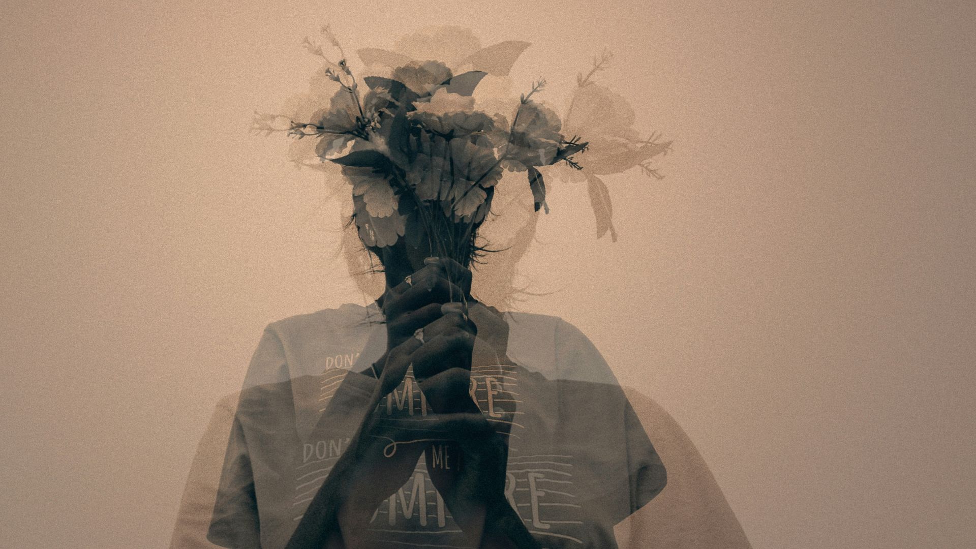 gray scale photo of man holding flower