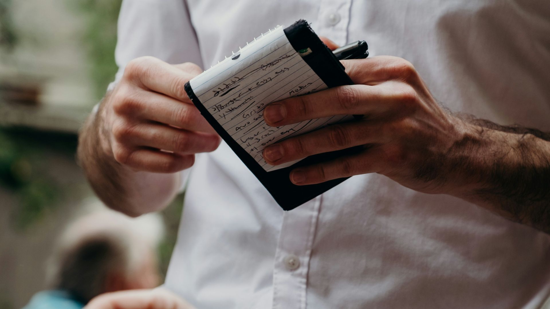 man in white button up shirt holding black and white box