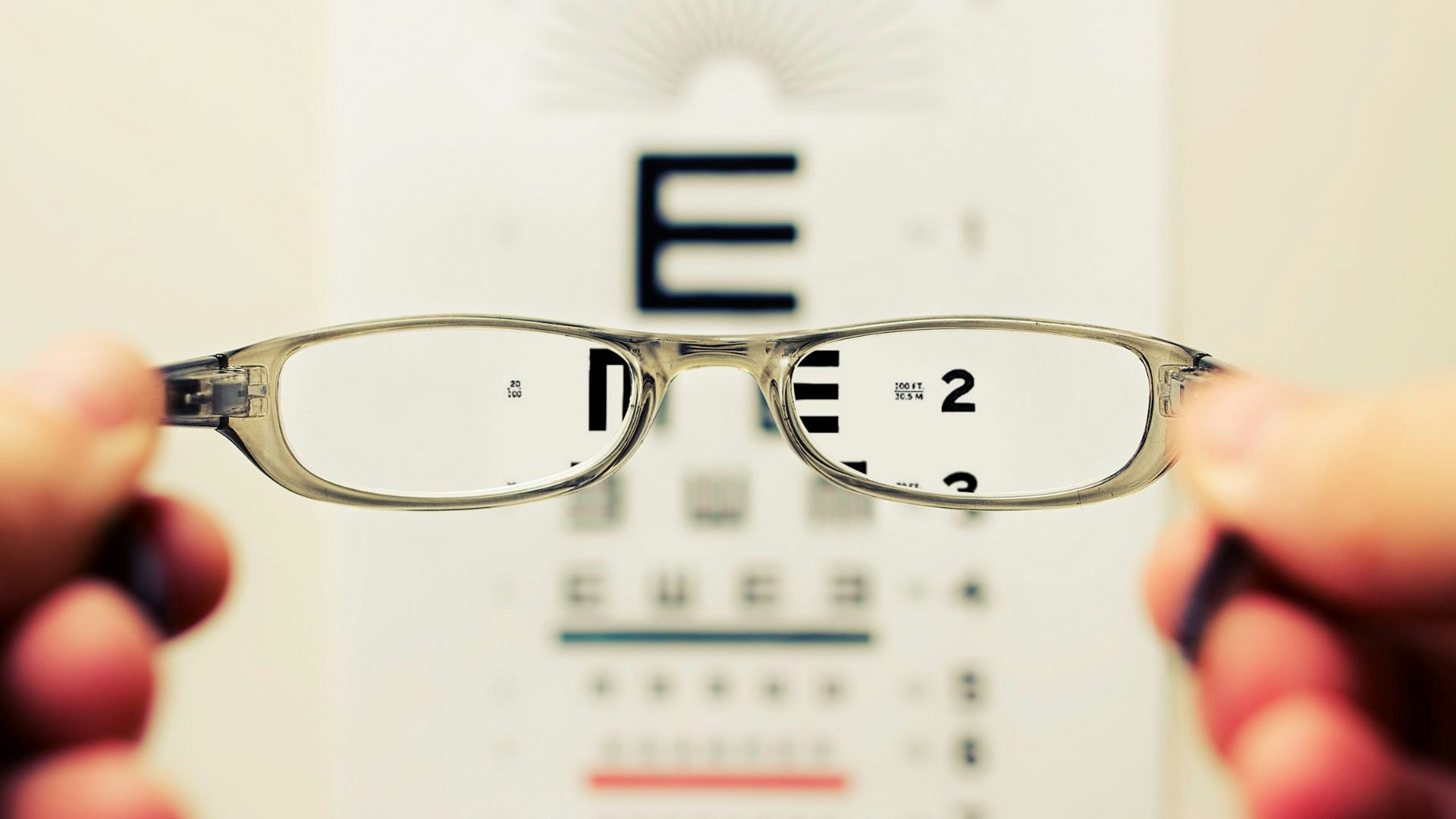 person holding eyeglasses