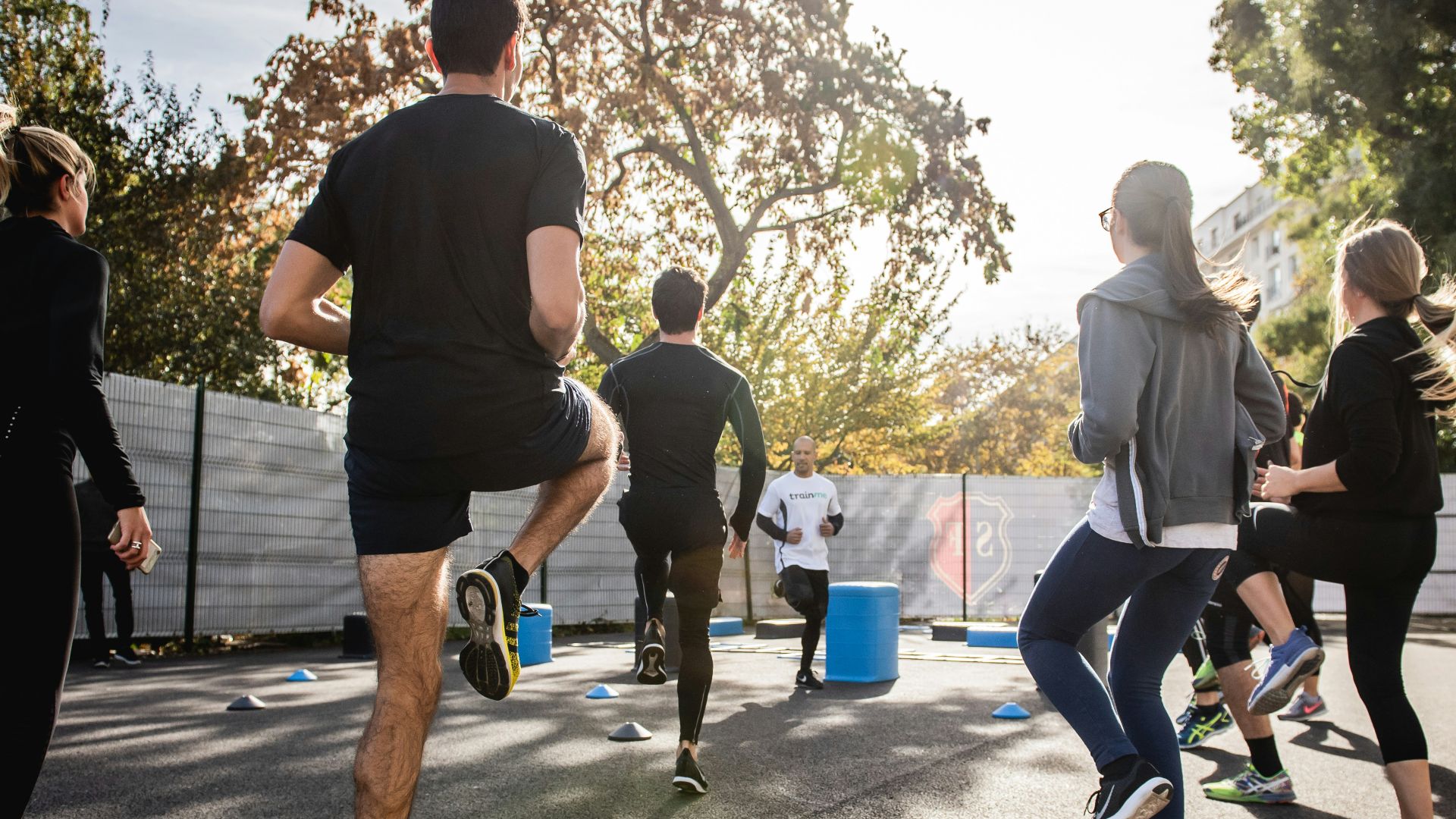 man in black t-shirt and black shorts running on road during daytime