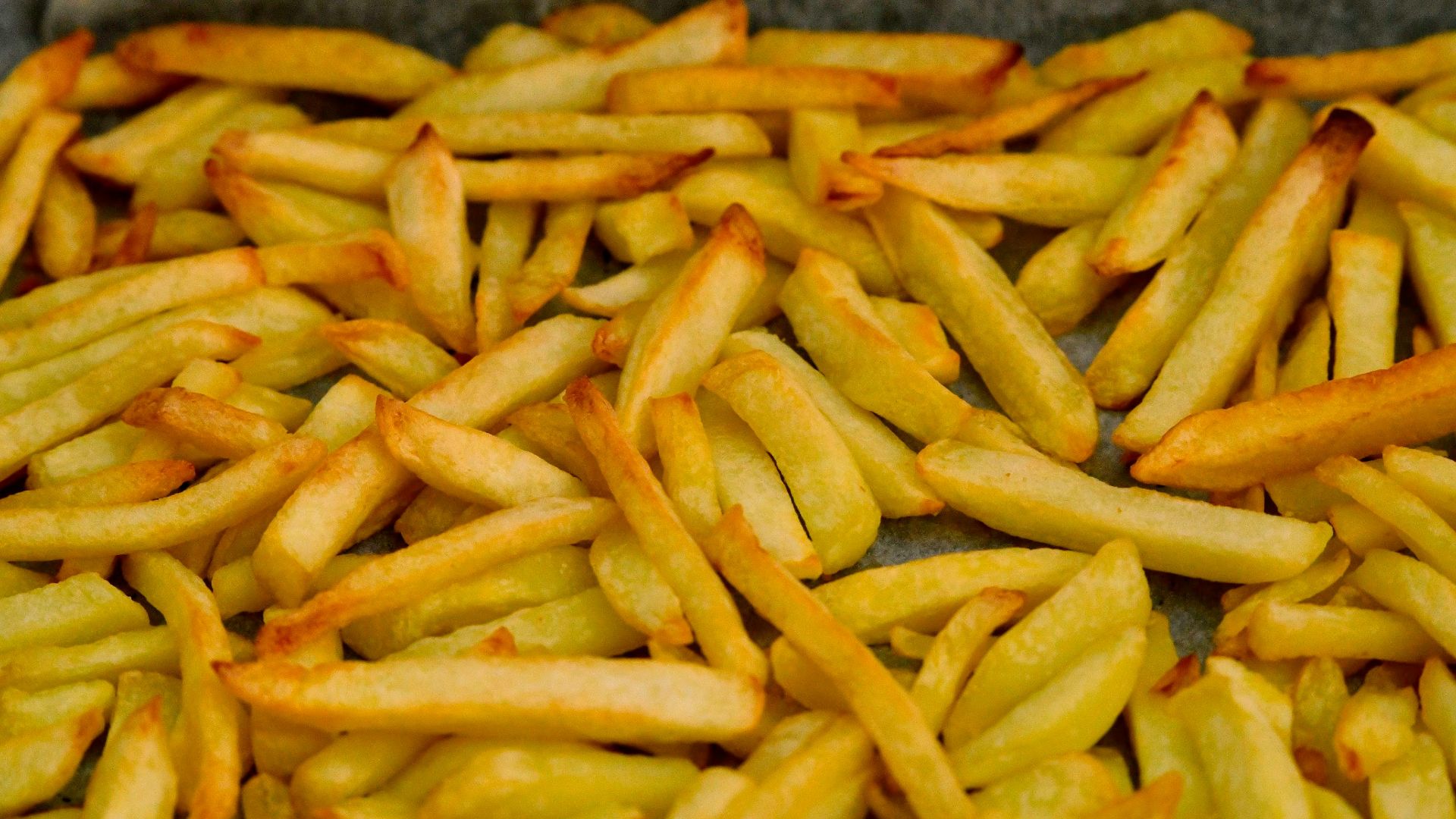 A pile of french fries sitting on top of a table