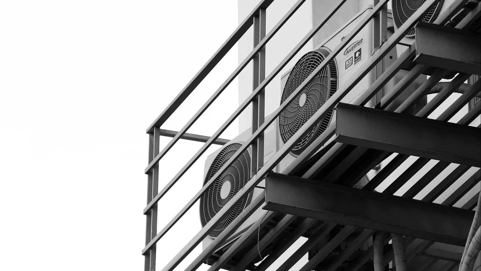 a black and white photo of a clock on a building