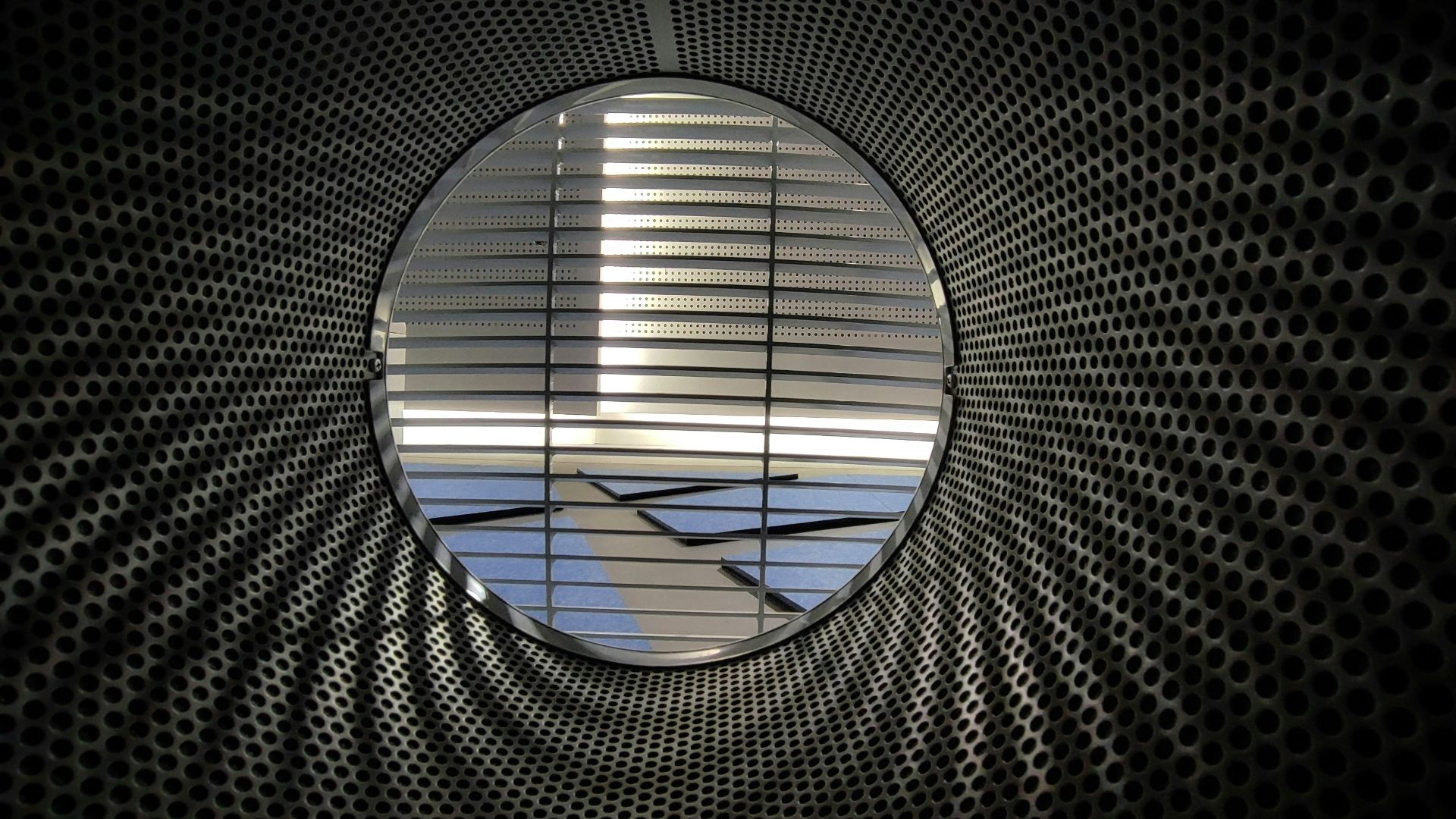 an airplane is seen through a circular window