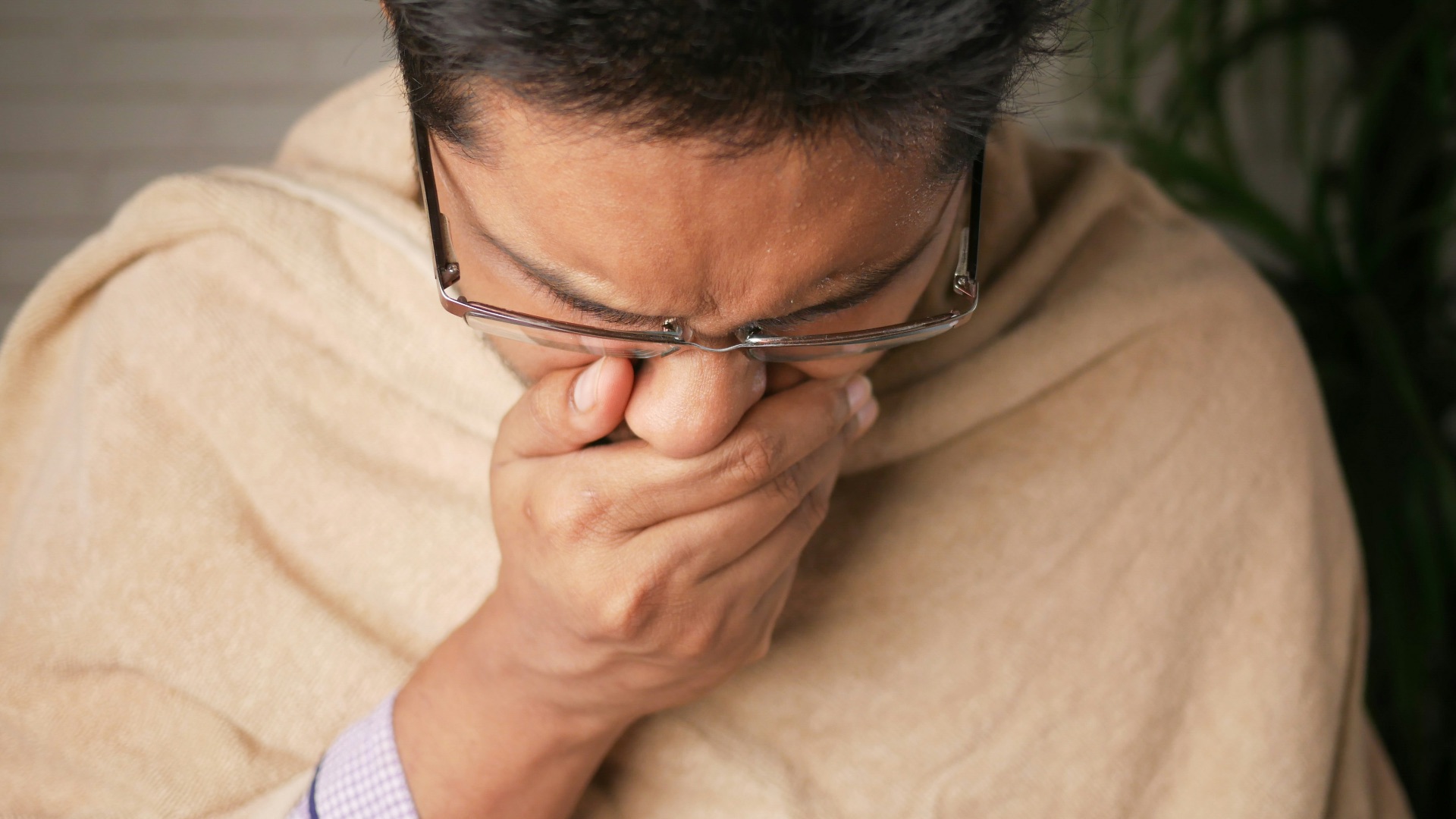 man in brown sweater wearing black framed eyeglasses
