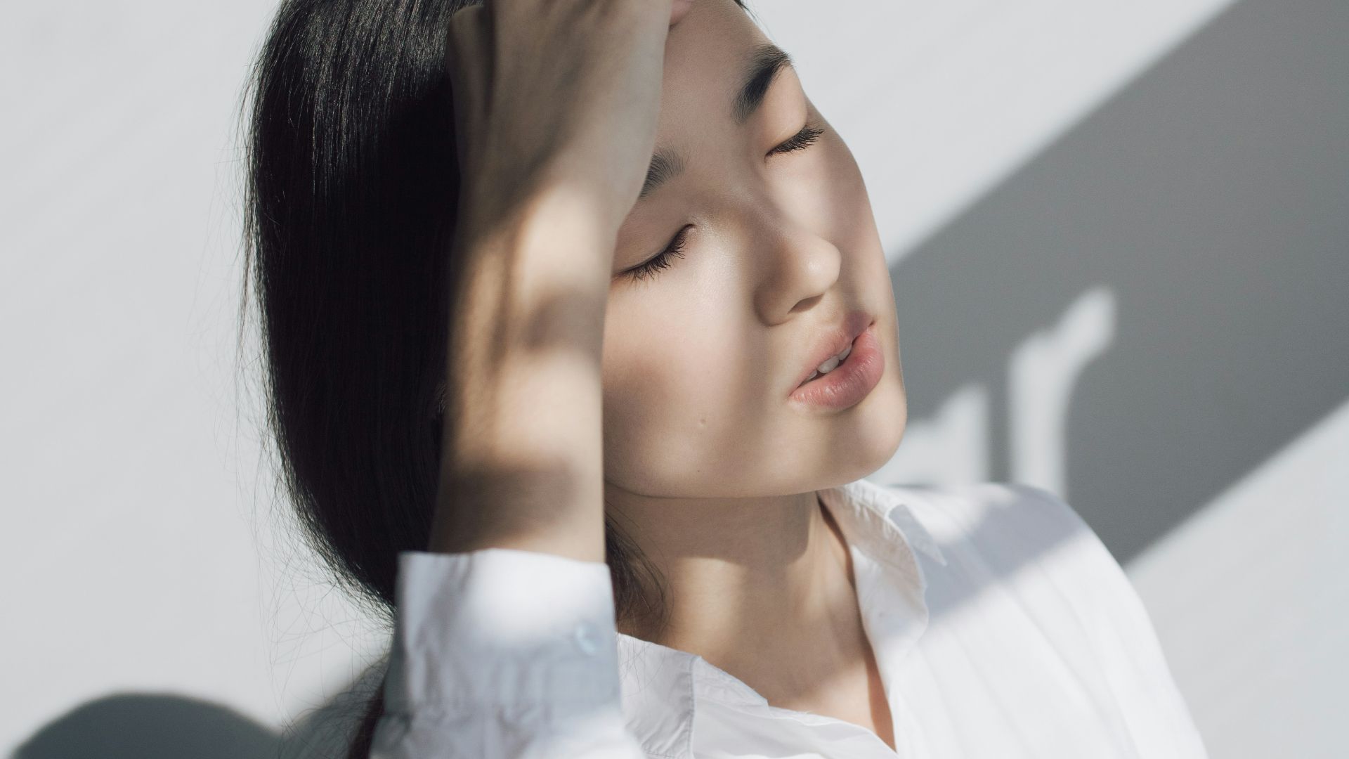 woman leaning on white table