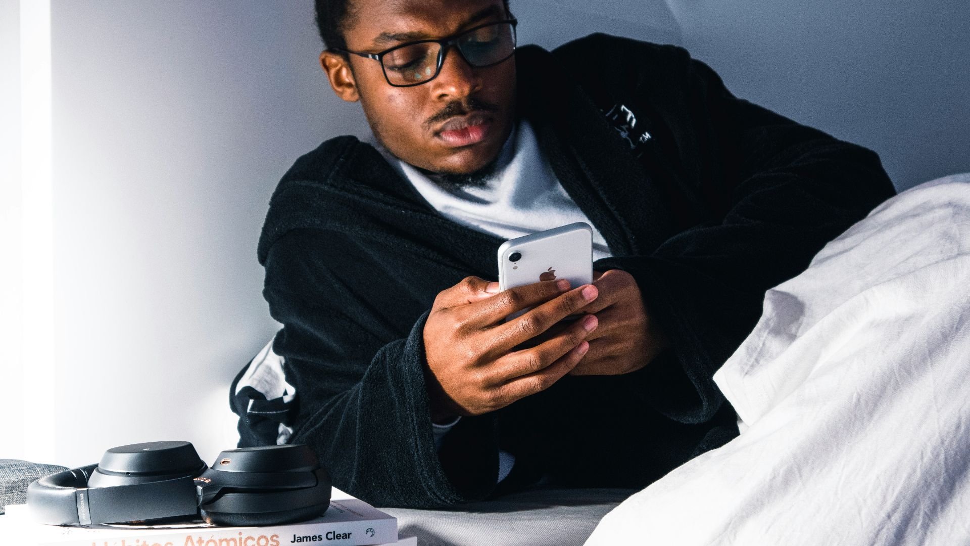 man in black jacket wearing black framed eyeglasses