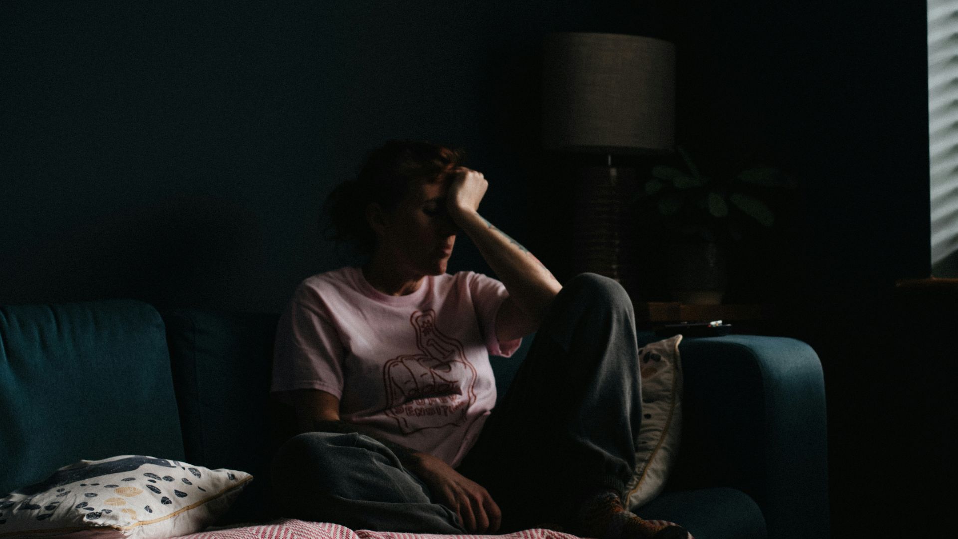 woman in purple dress sitting on couch