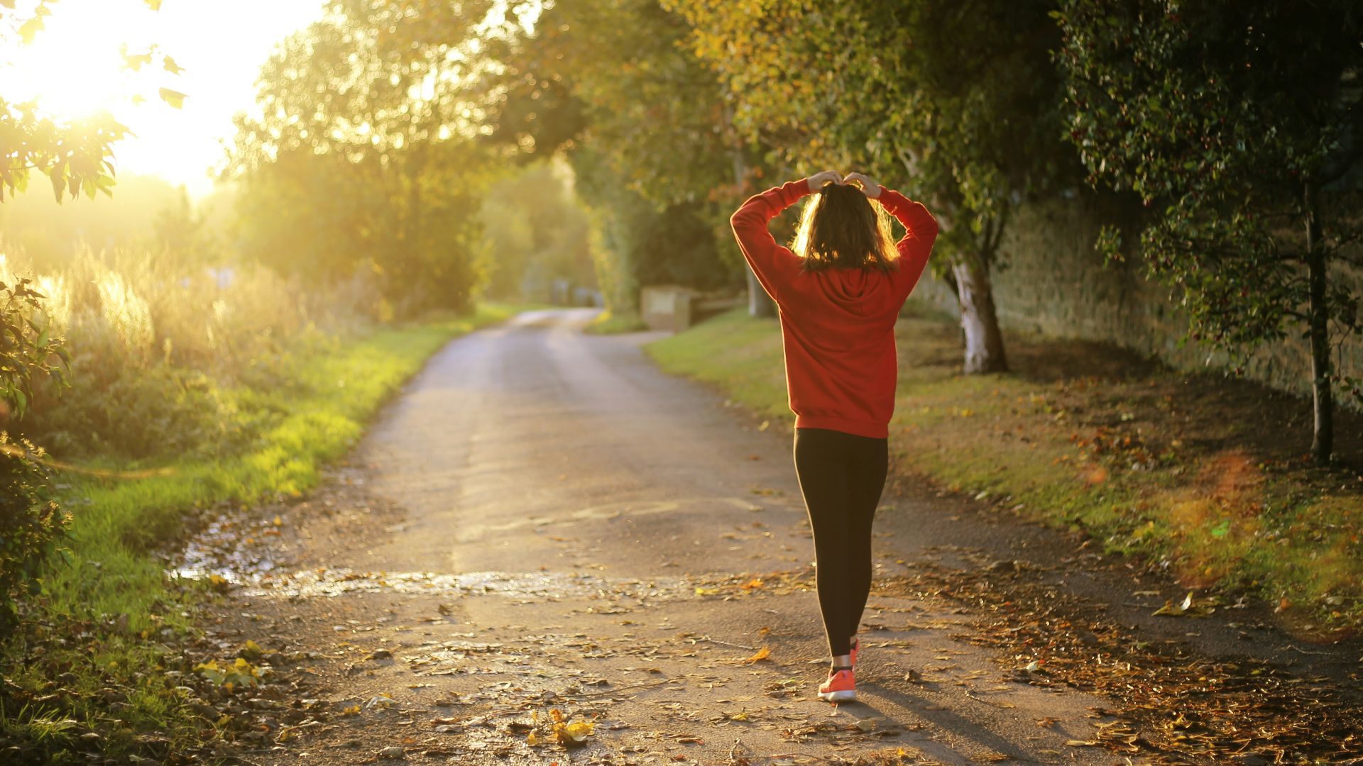 woman walking on pathway during daytime