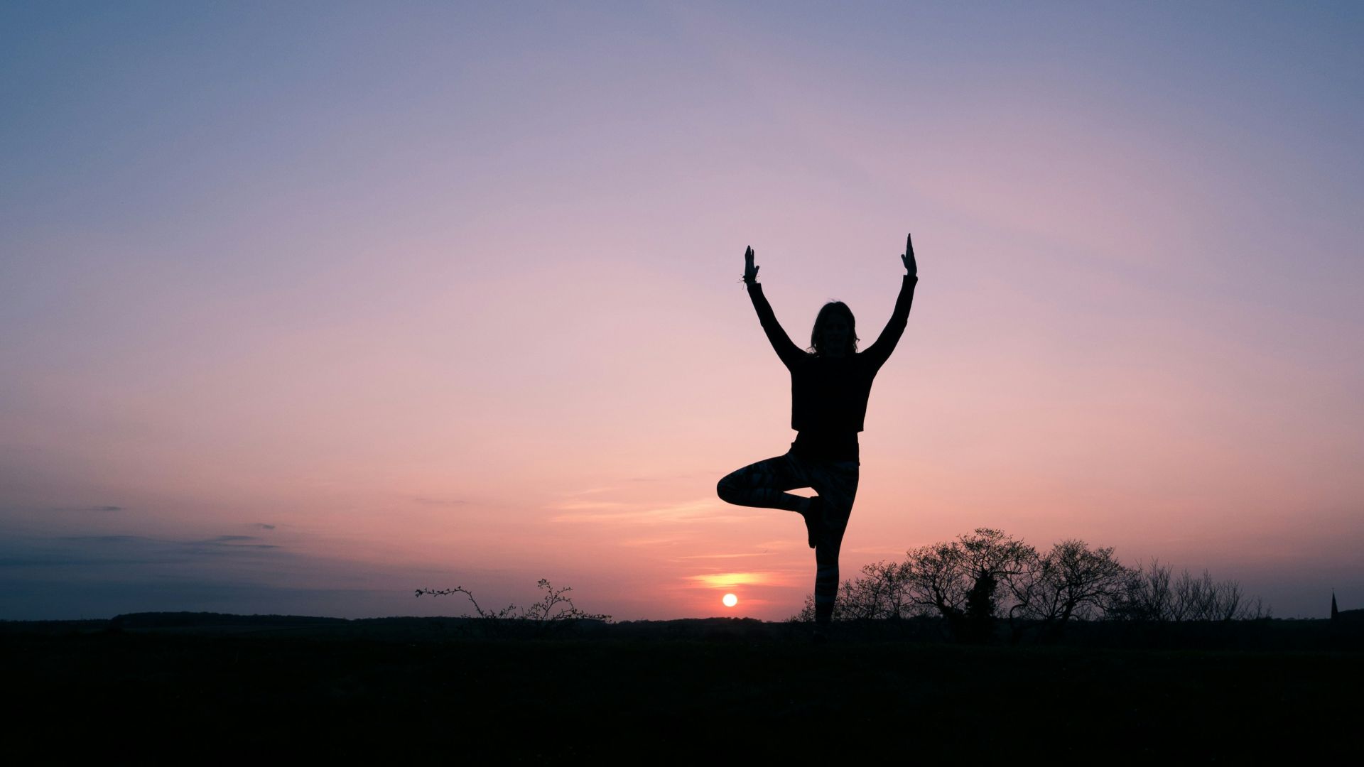 silhouette of person balancing using 1 foot