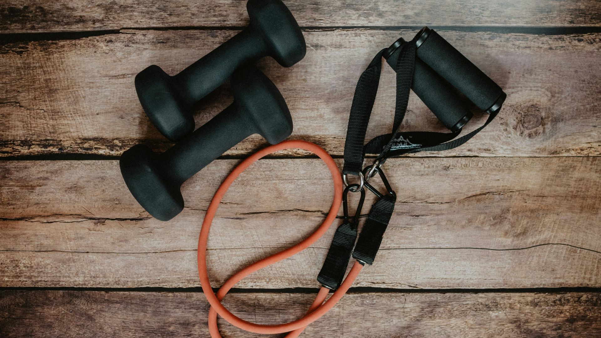 orange and black usb cable on brown wooden surface