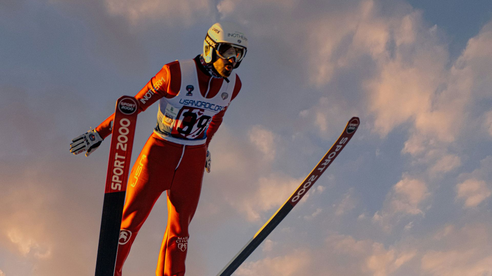 a man flying through the air while riding skis