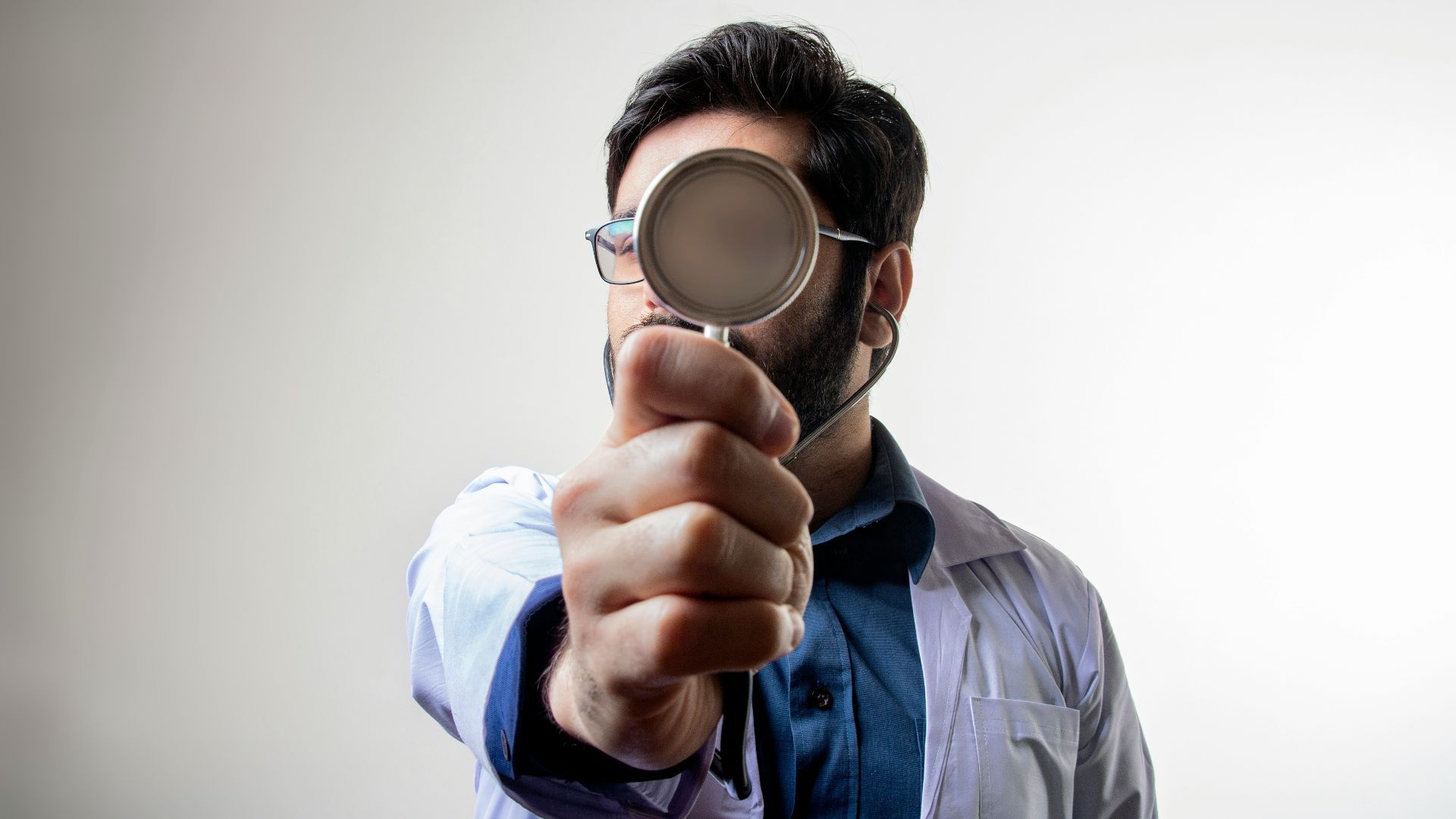 man in blue dress shirt wearing black framed eyeglasses