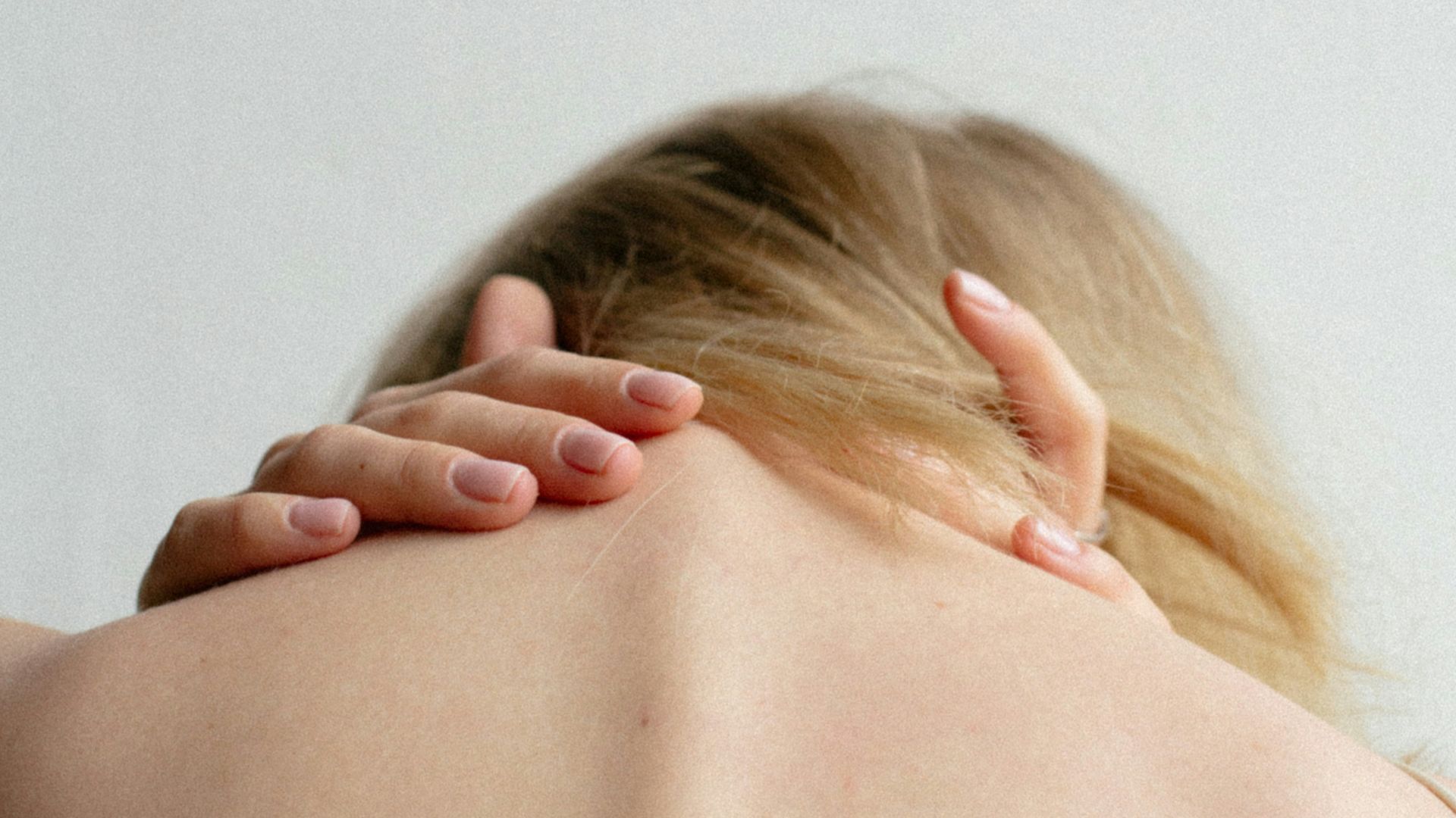 woman covering her breast with her hand