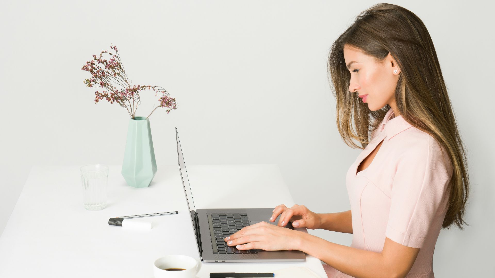 woman sitting while using laptop