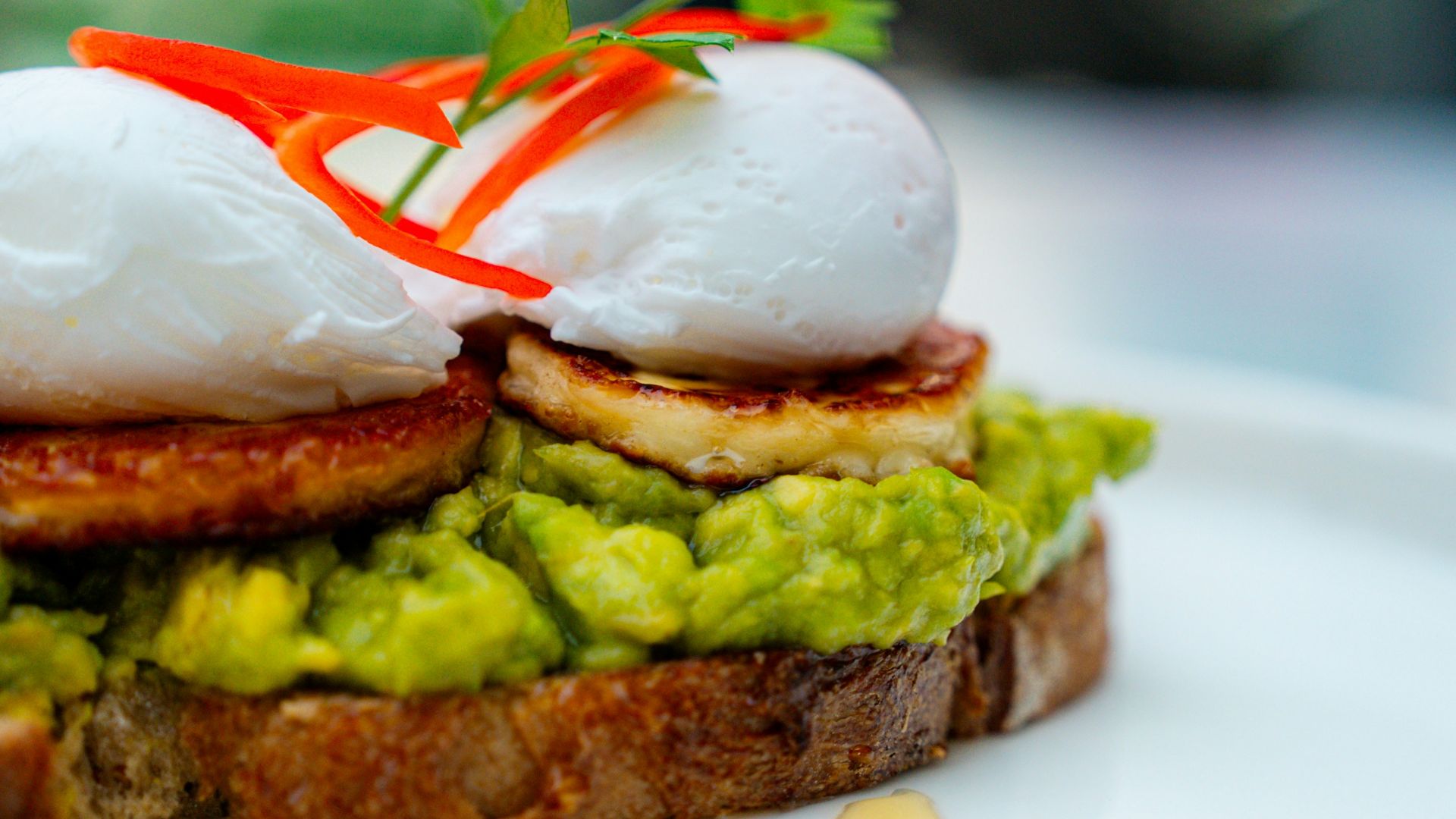 Avocado toast with poached eggs and chili